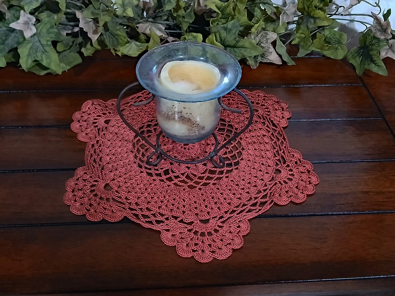 Handmade 13-inch round crochet lace doily in a rich rust orange color featuring intricate scalloped edges and pointed details