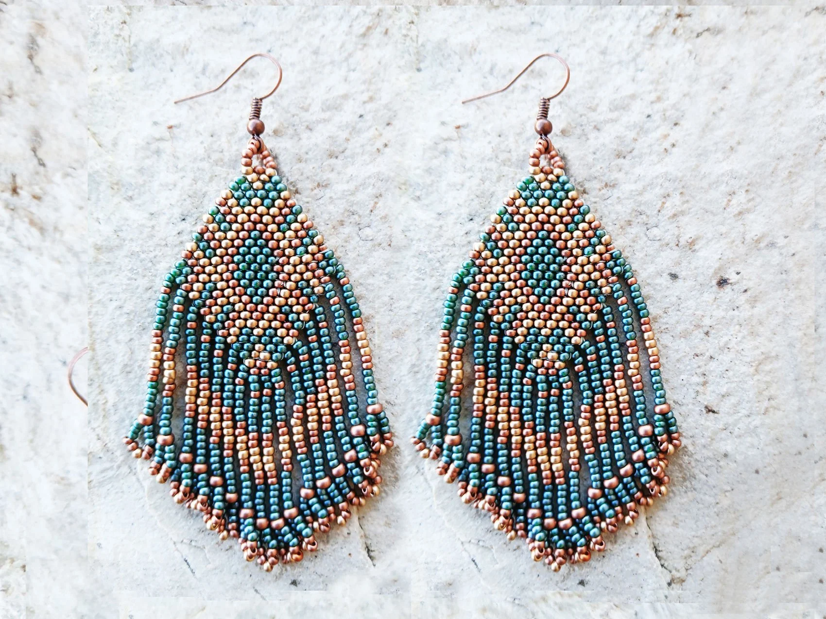 Handmade Southwestern beaded fringe dangle earrings handwoven in an earthy green, metallic gold, and copper color palette.