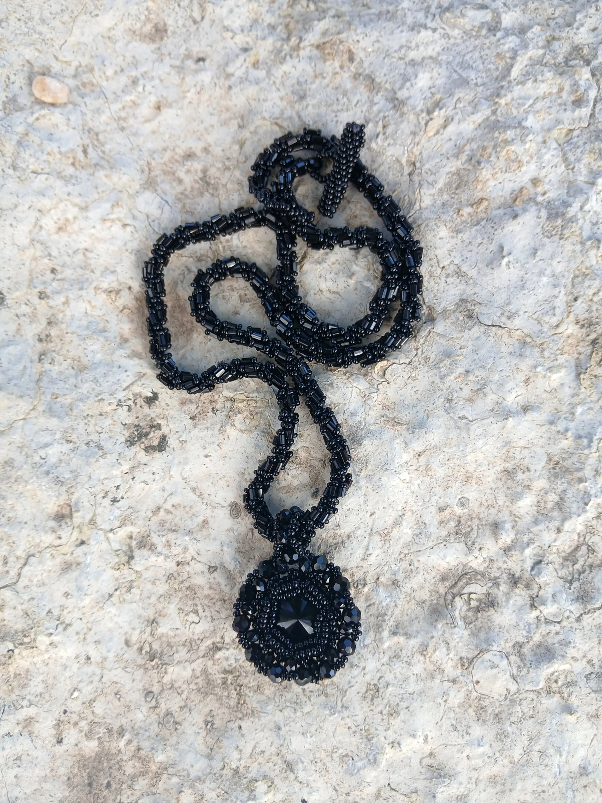 Handmade vintage style necklace with a faceted black Rivoli crystal cabochon and detailed hex bugle and small seed beads