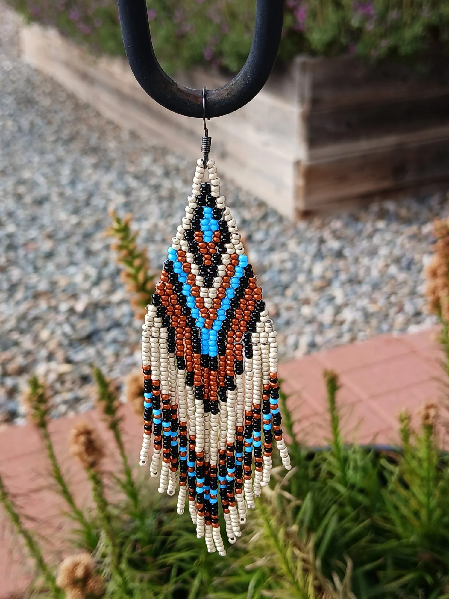 Handmade 5” beaded fringe earrings handwoven in chevron brick stitch with earthy sky blue, matte silver, black, and copper.