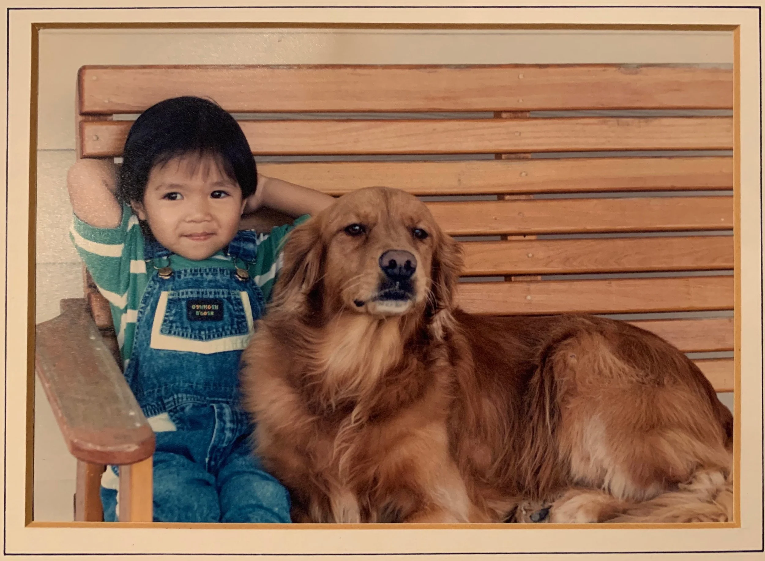 Childhood photo of Dr. Noah Andone as a toddler with a golden retriever dog in Jacksonville, FL