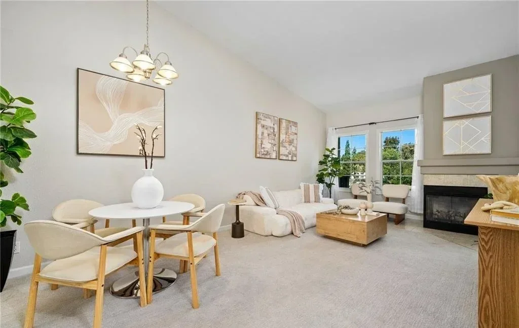 Dining and living share one room here, so both ends are furnished low and nothing is allowed to meet in the middle. From the entry the vault and the full depth of the space read in one look, which is what a one-bedroom plan needs most.