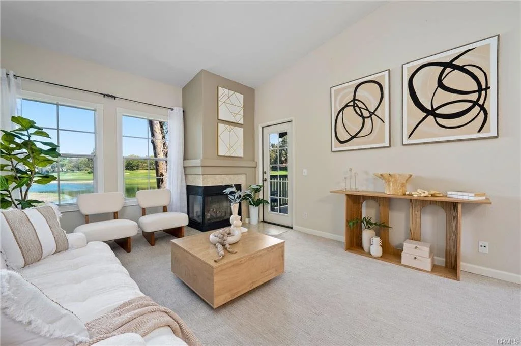 A thoughtfully arranged dining setting anchors the open floor plan while maintaining clear sightlines into the adjoining living space. Soft textures and contemporary accents create an atmosphere that feels welcoming yet distinctly upscale.