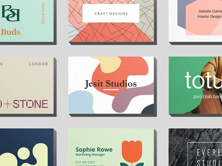 A collection of business cards with various designs and colors.