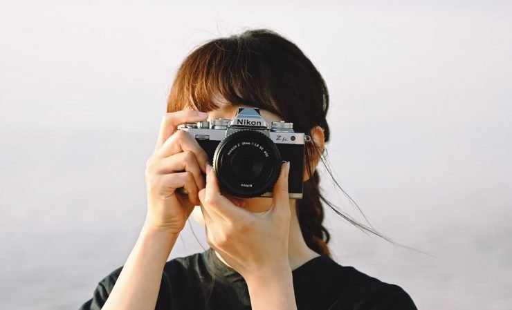 Lucid Pod is a Brand Strategy Studio. The founder, Lisa Villagrán takes a photo with her Nikon camera.