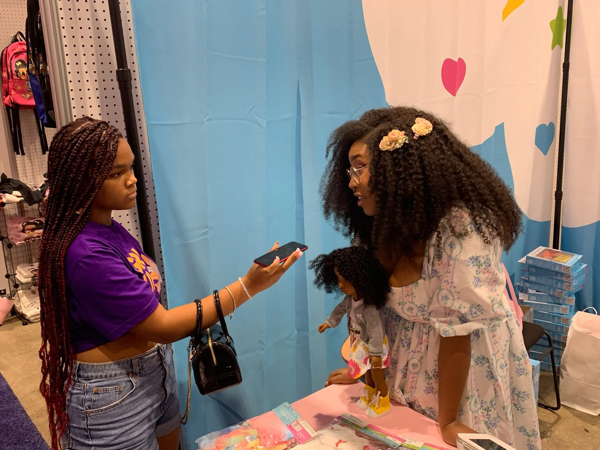 Young girl interviewing another young girl