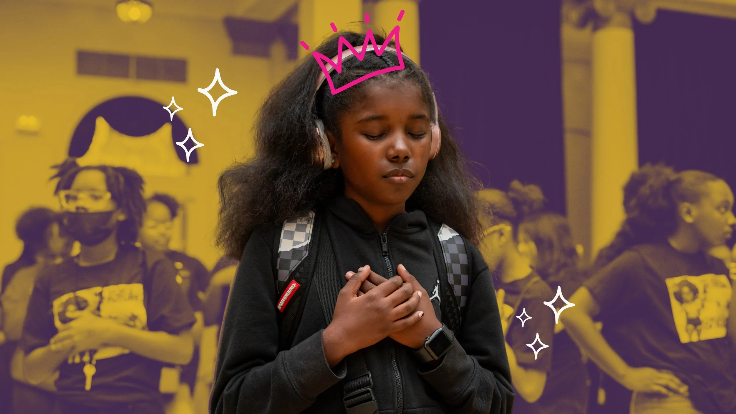 Young girl with her eyes closed and hands over her heart.