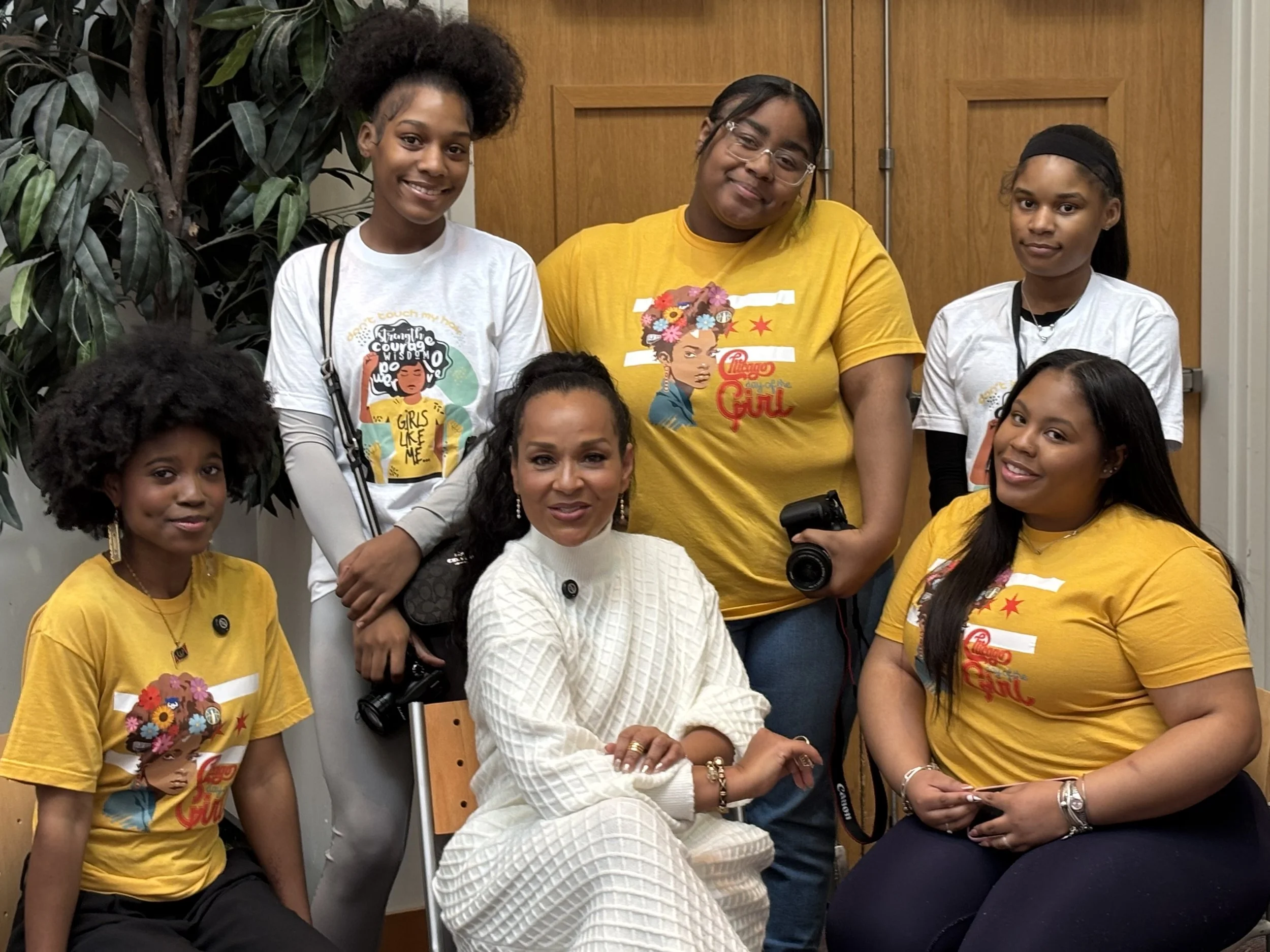 Girls Like Me program posing with cameras and celebrity, Lisa Raye.