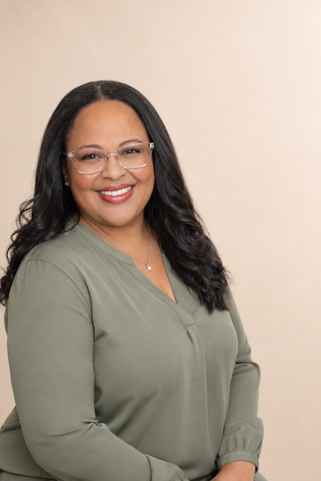 Christel Raquel Walker, MA, LPC, founder of Walker Wellness Collective, wearing sage green.