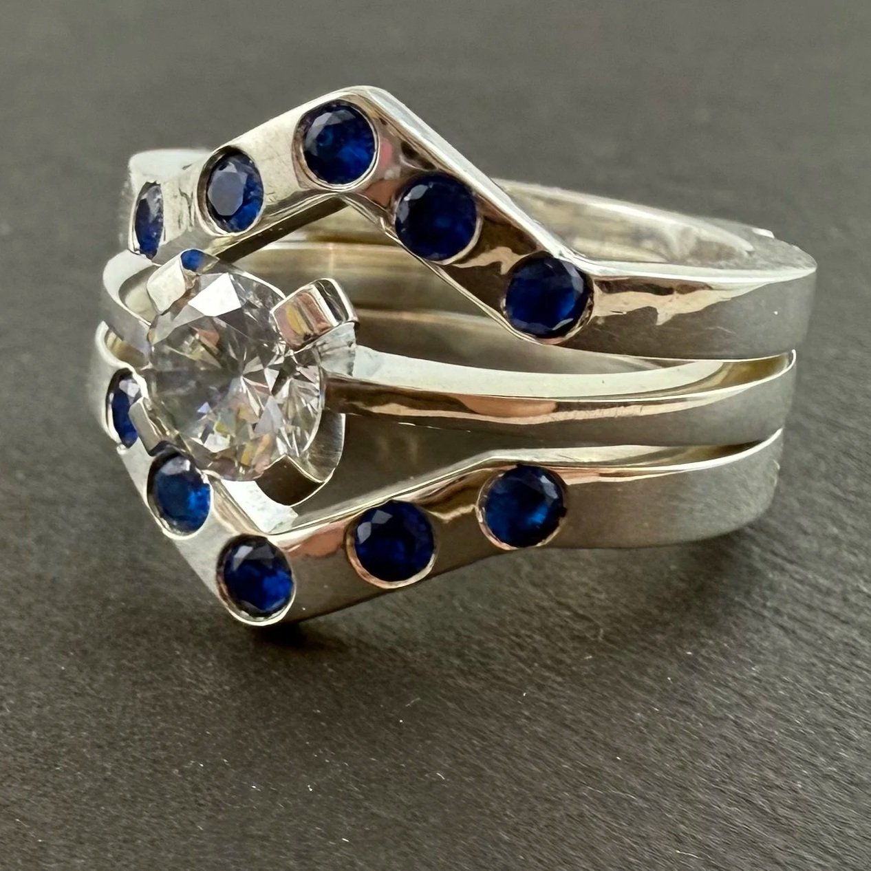 Solitaire engagement ring and chevron ring jacket. Sterling silver, cubic zirconia and synthetic spinel