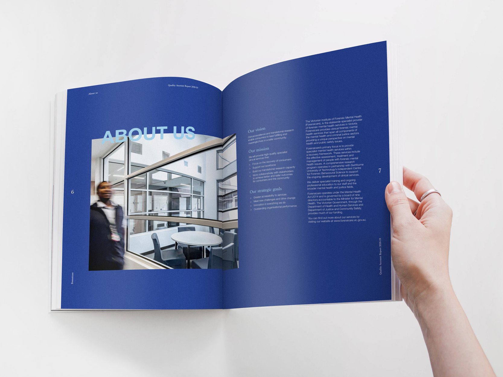 Open booklet showing an 'About Us' section with a photo of a woman walking in a modern office building, and blue background with white text.