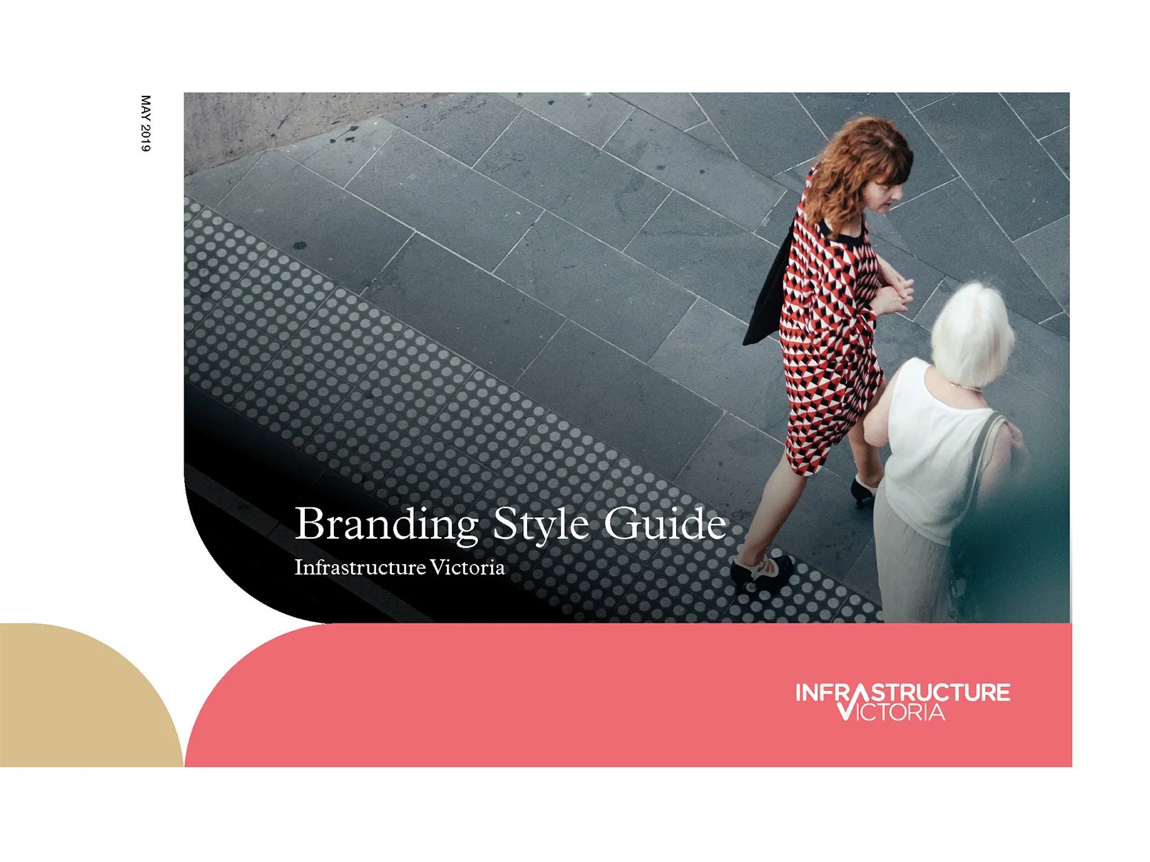 Cover page of the Branding Style Guide for Infrastructure Victoria, featuring an overhead view of two women walking on a sidewalk with one wearing a red and black geometric patterned dress and the other in a white dress.
