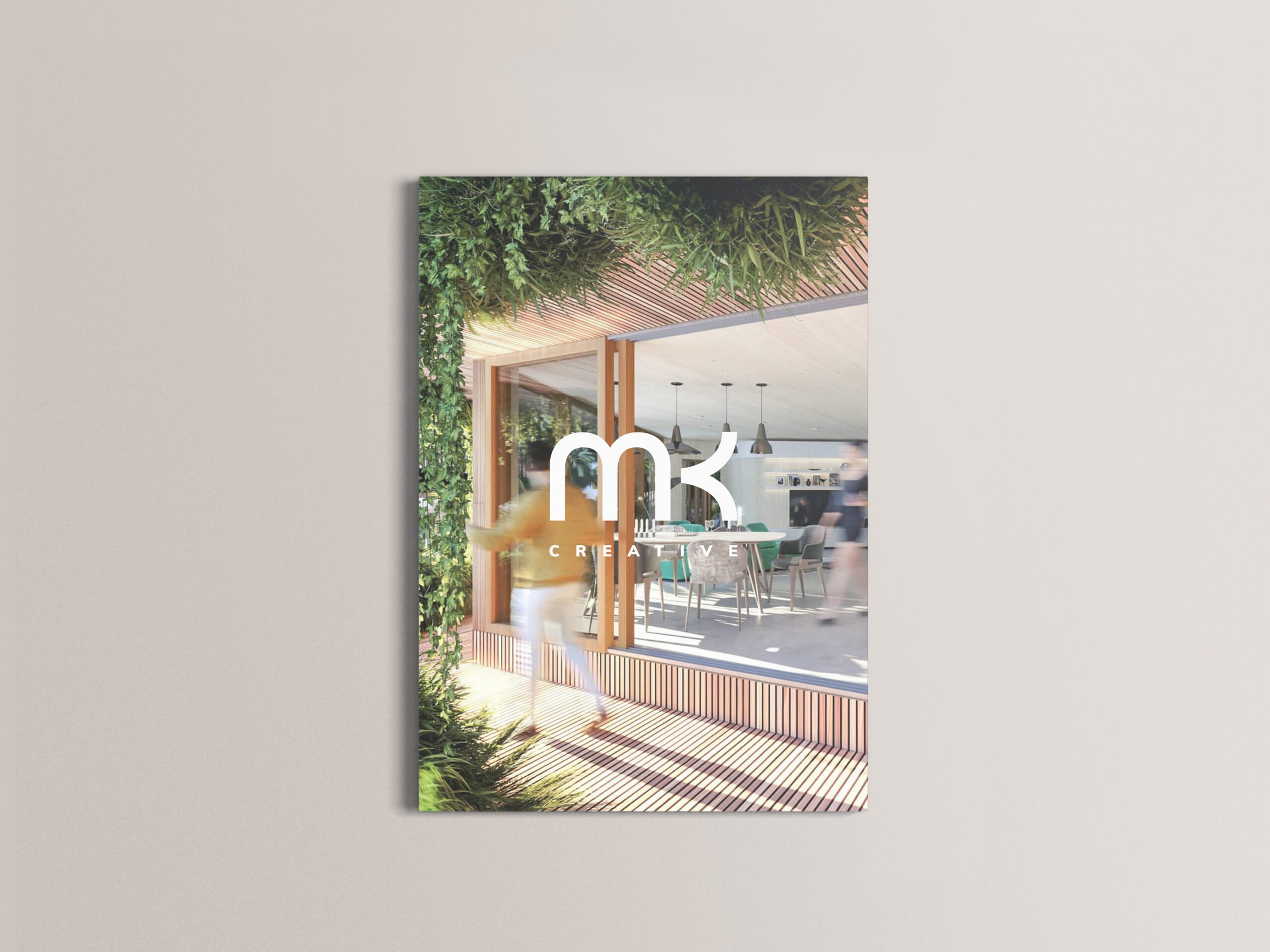 The cover of a booklet, with an interior view of a modern room with large windows, wooden accents, and hanging lights, decorated with indoor plants and greenery.
