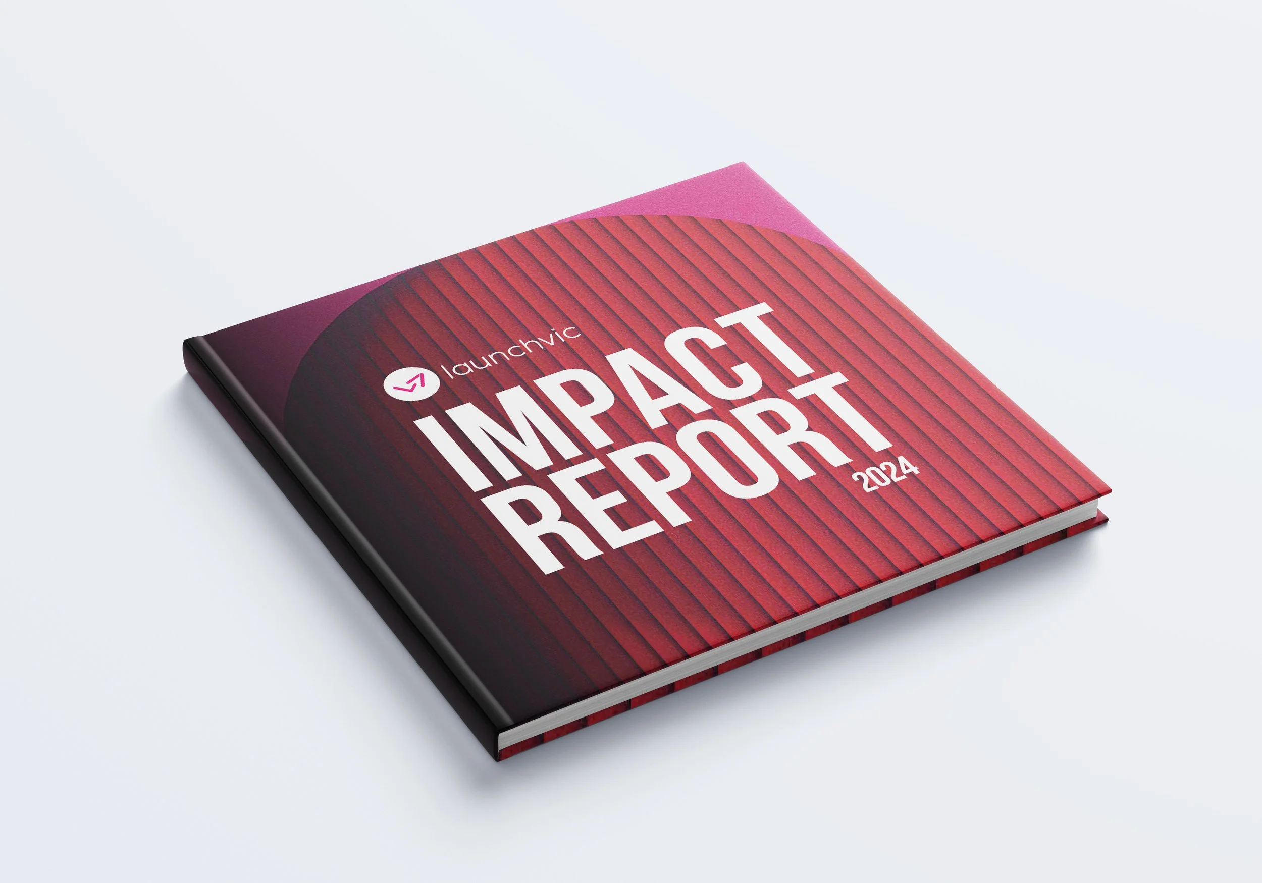 A hardcover book titled 'Impact Report 2024' by launchvic, with a red and deep purple striped cover, lying on a white surface.