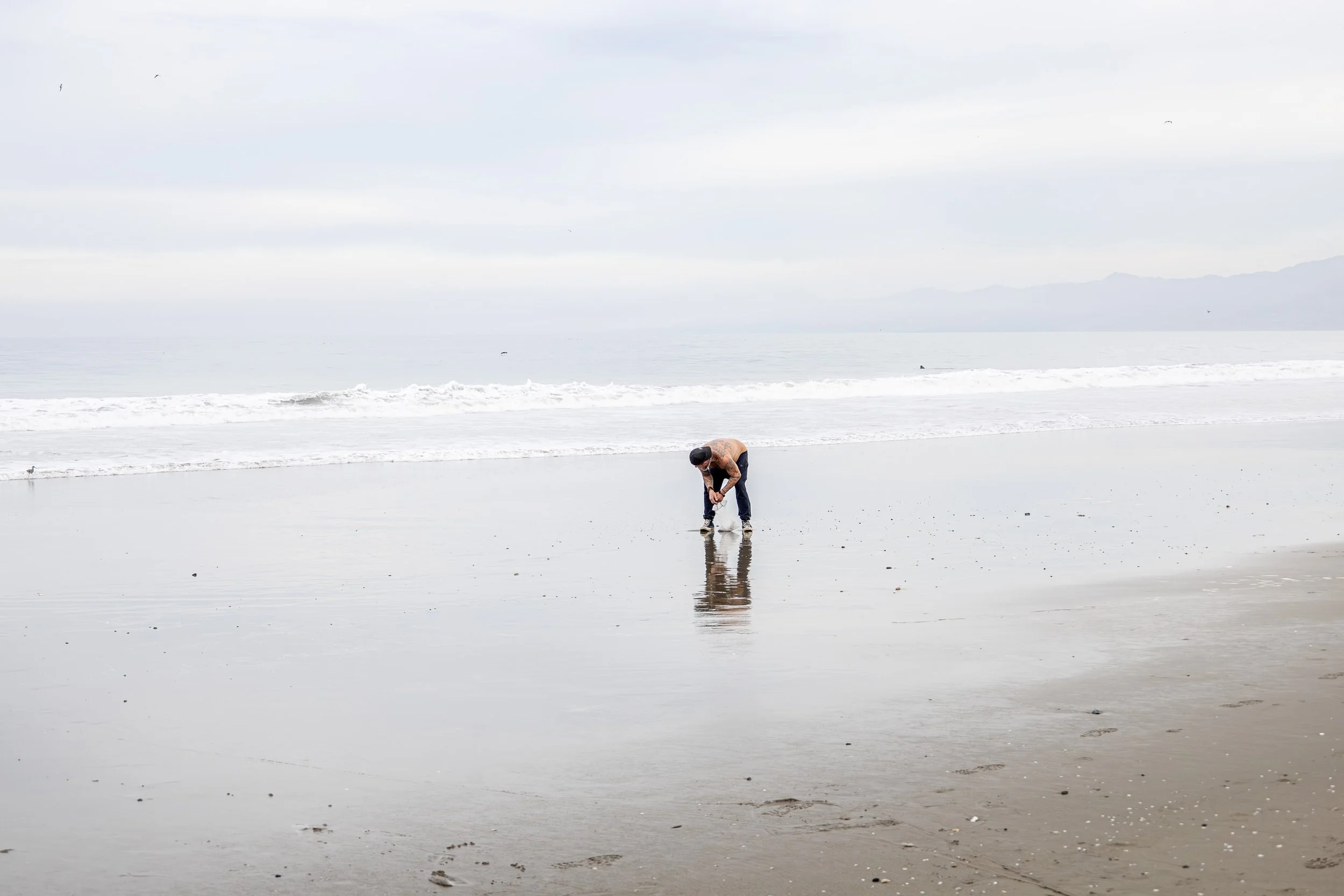 candid man on venice beach at dawn