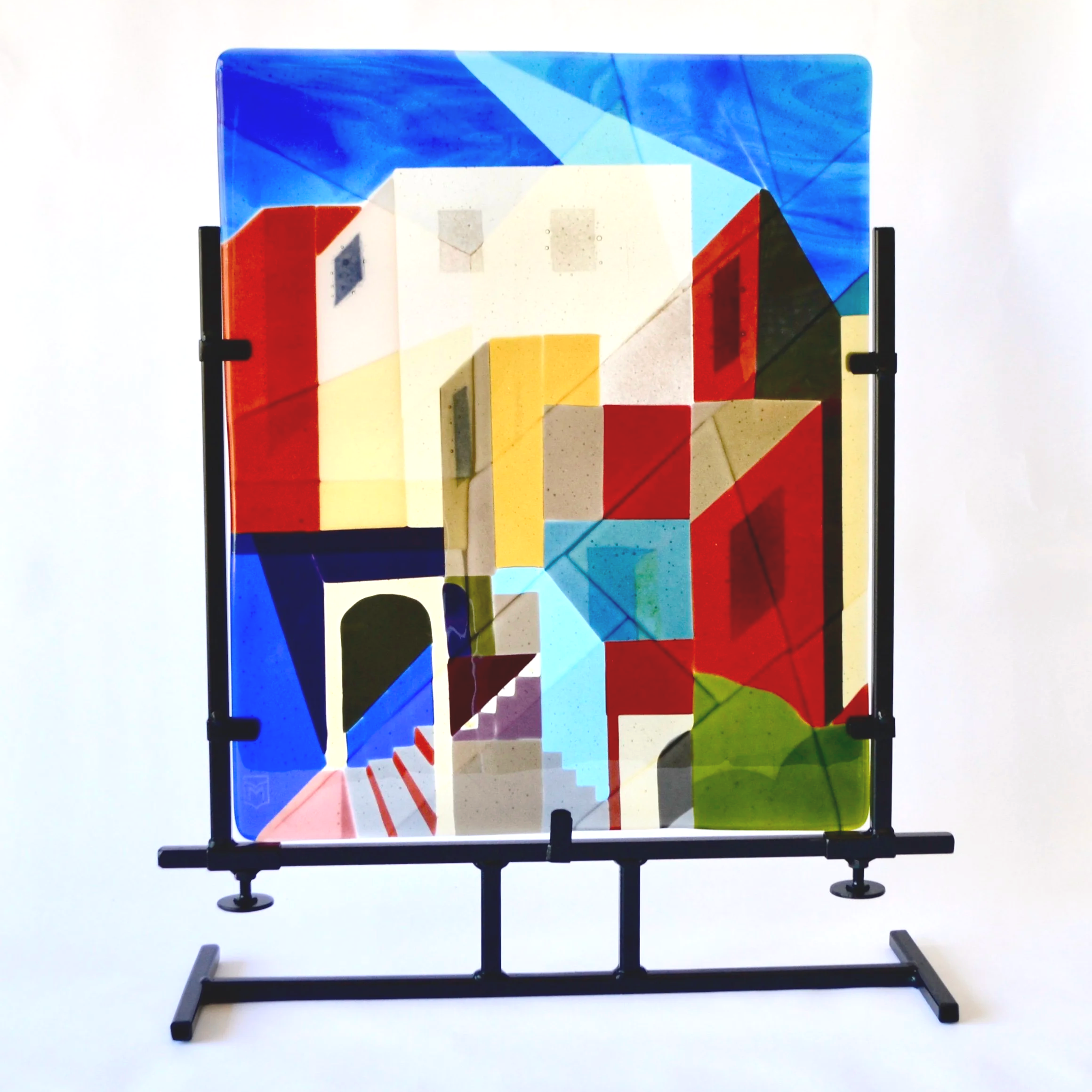 Urban Landscape - layered fused glass panel in cubist style, supported by steel stand.