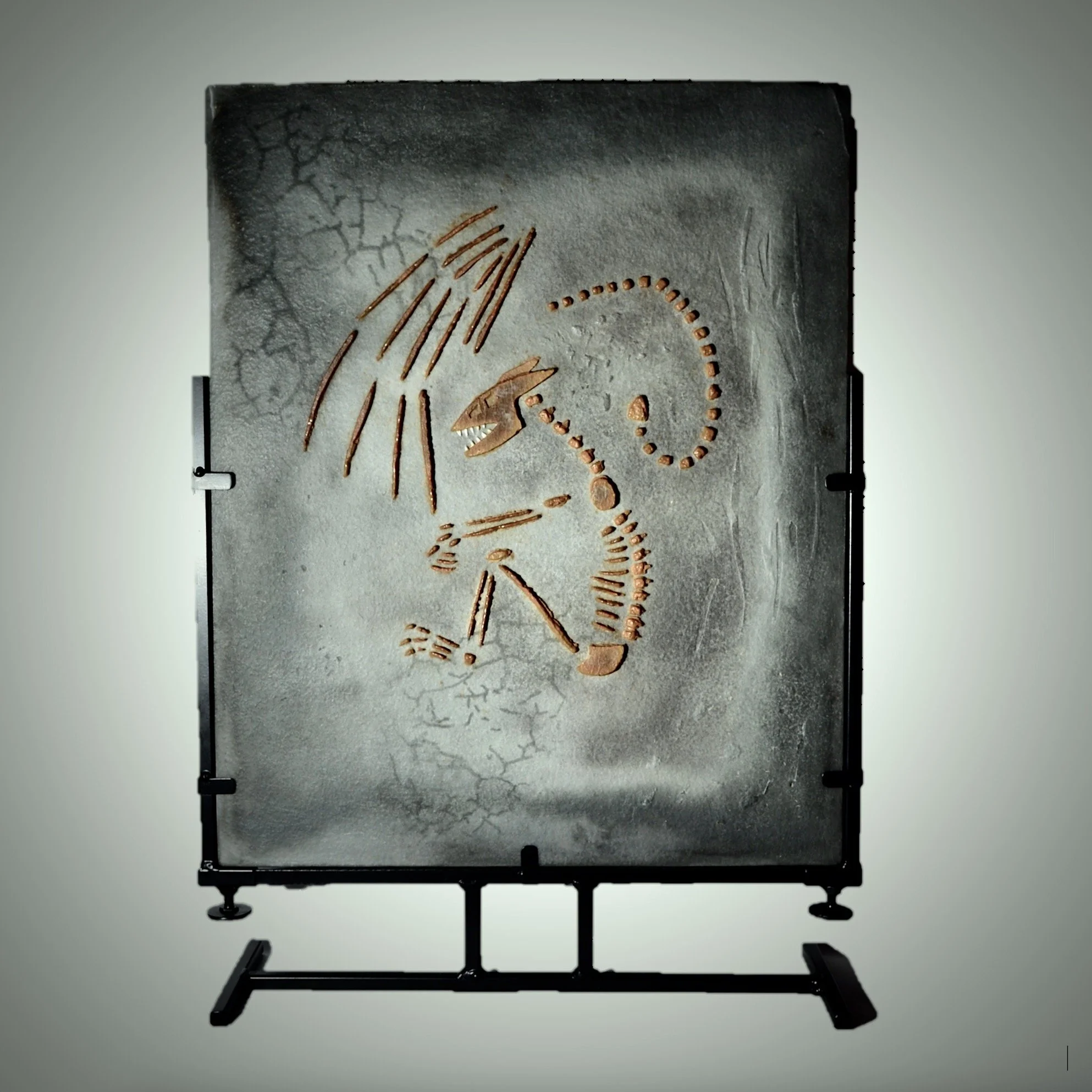 Dracolith - surface cast glass panel depicting fossilized dragon, supported by steel stand.