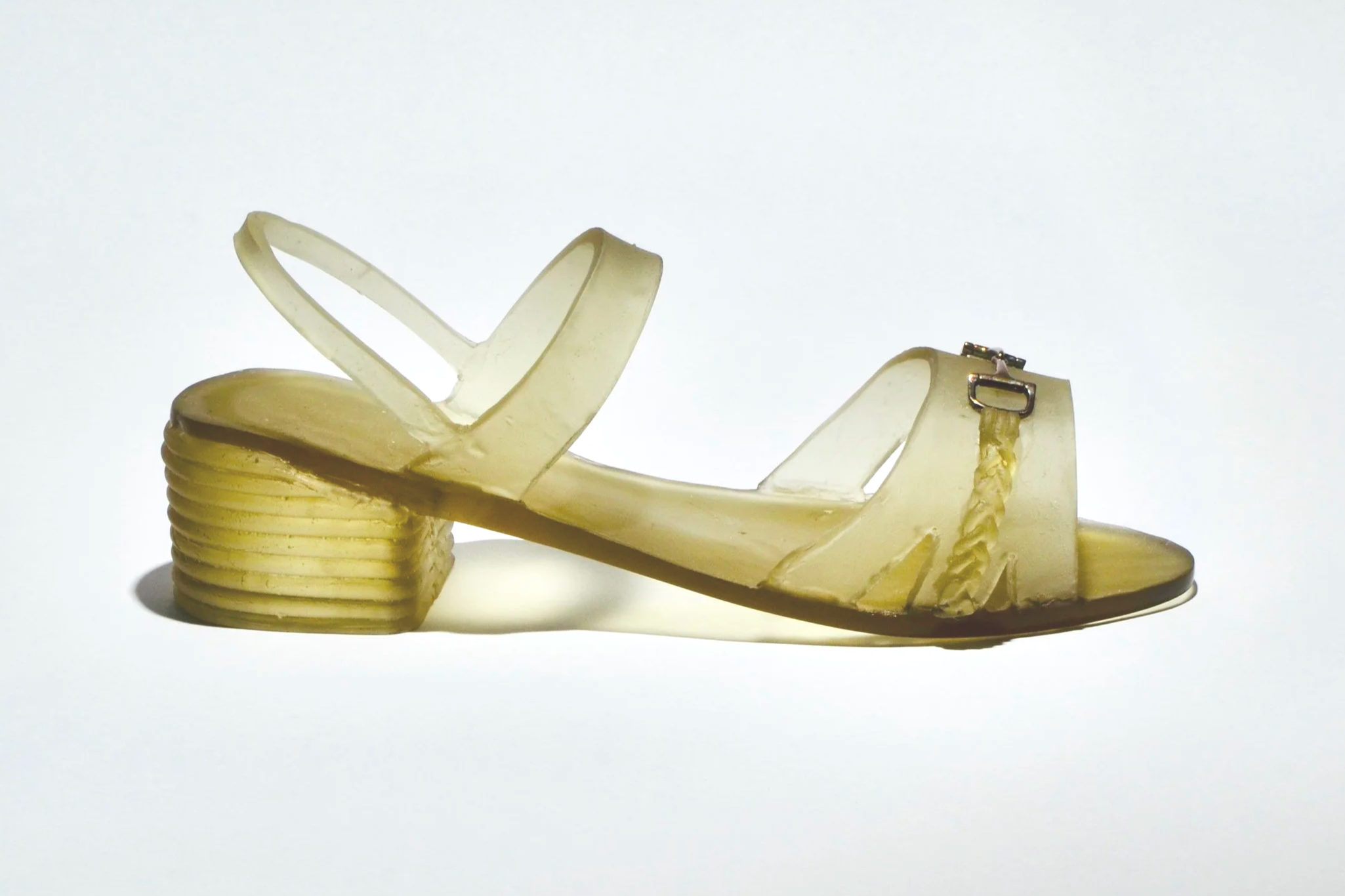 A vintage yellow block-heeled sandal with a strap across the toes and an ankle buckle, displayed against a plain white background.