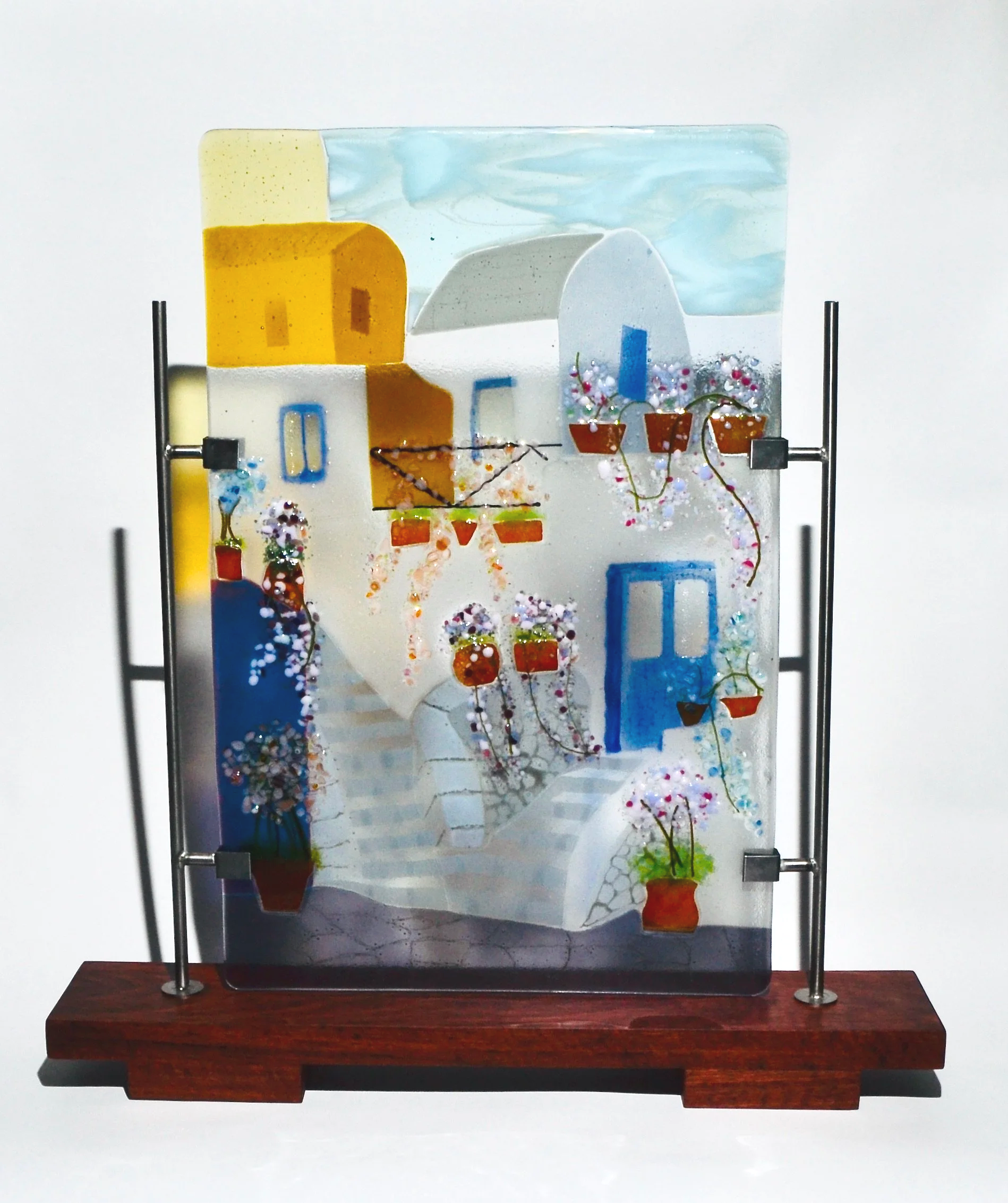 Mediterranean Panel - layered fused glass panel representing Mediterranean Village, supported by stainless steel and jarrah stand.