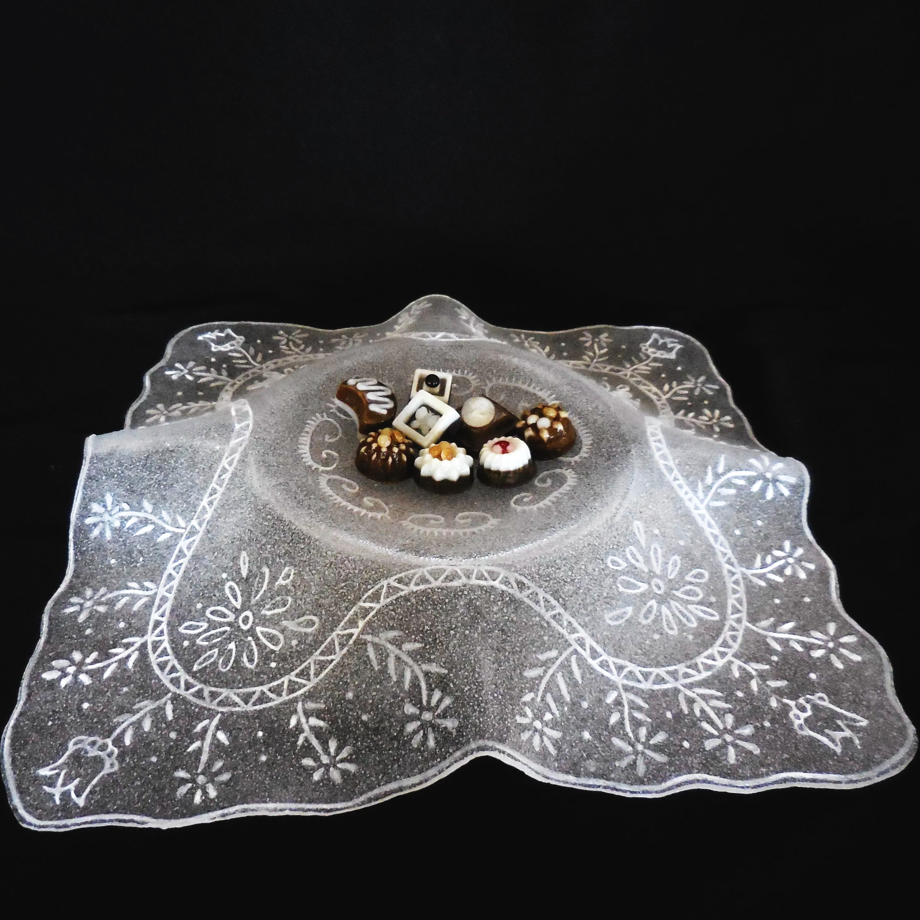 Lacy Bowl with chocolates - chocolates made from glass sit in a pate de verre bowl.
