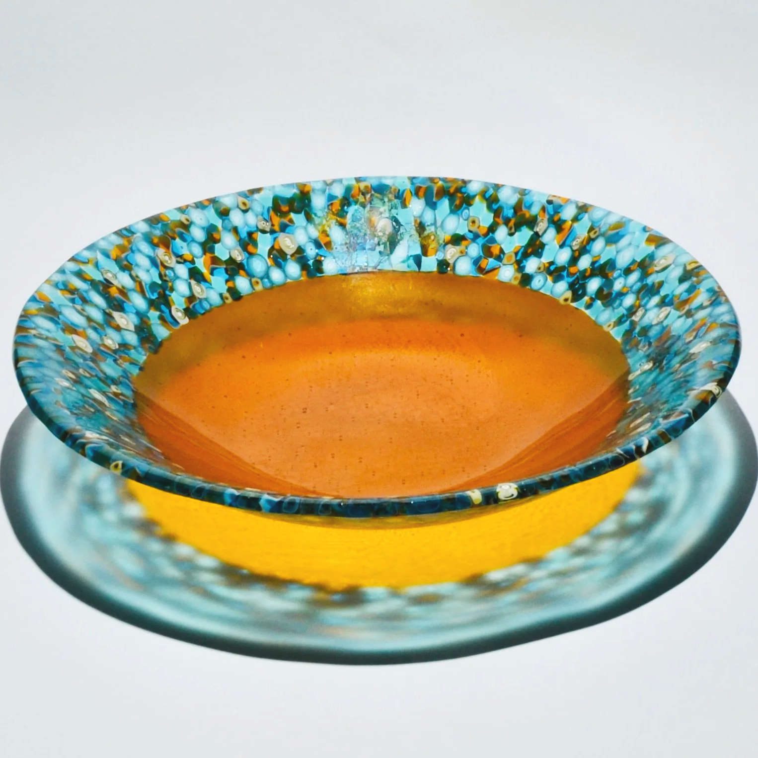 Gathering Bowl - amber - an amber glass bowl surrounded by hand pulled blue, white and amber murrine.