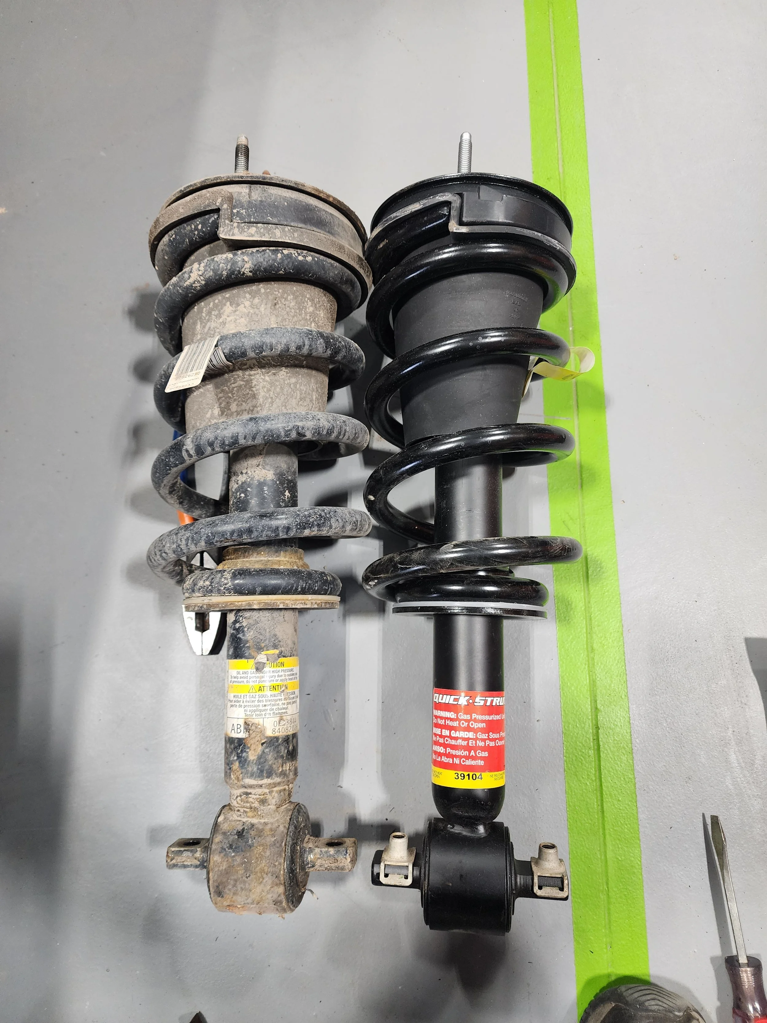 Comparison of an old and a new car suspension strut assembly