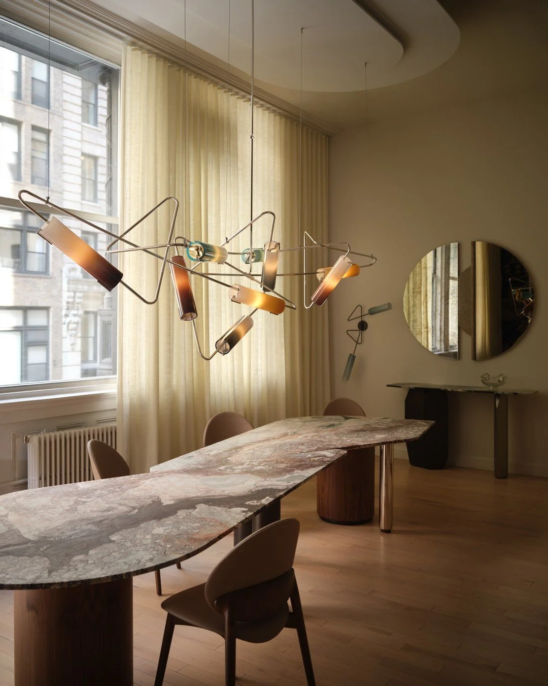 NOTES FROM THE SOURCE.⁠
⁠
The Incontro Dining Table by Avram Rusu Studio started with a slab of marble. The custom Continuum chandelier hanging above it started with graffiti.⁠
⁠
Andreea, founder of Avram Rusu Studio, tends to fall for individual pie