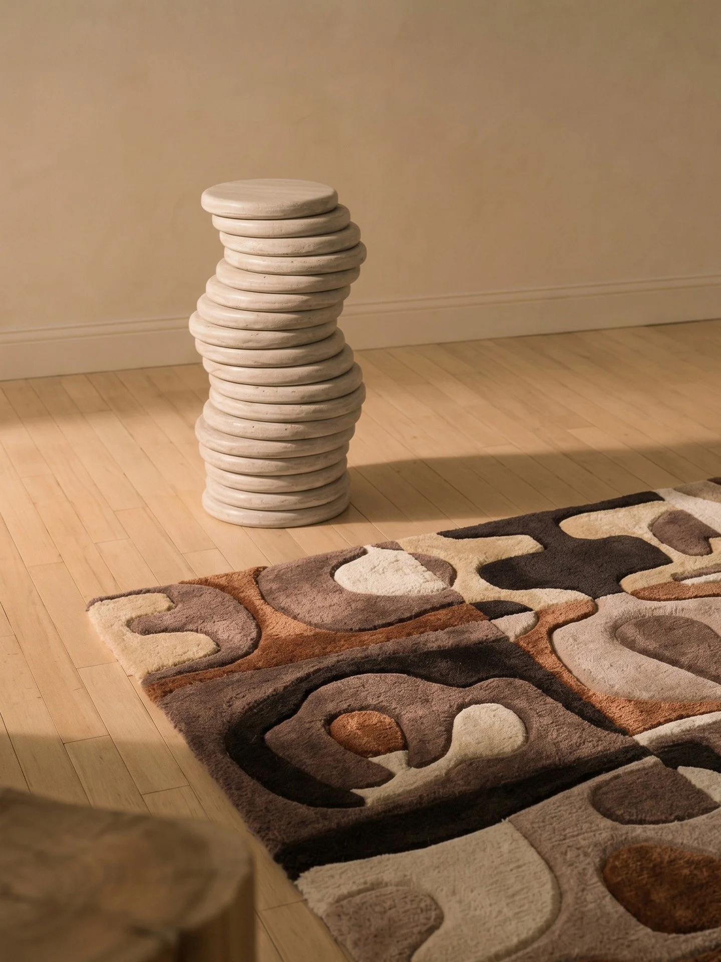 LIFE RUG + KORIS STOOL. Two very different approaches to movement. The 'Life Rug' from @katrienvanderschueren x @artandloom's new collection breaks organic forms into a loose grid of hand-knotted wool and silk, while @manifesteedition's Koris Stool s