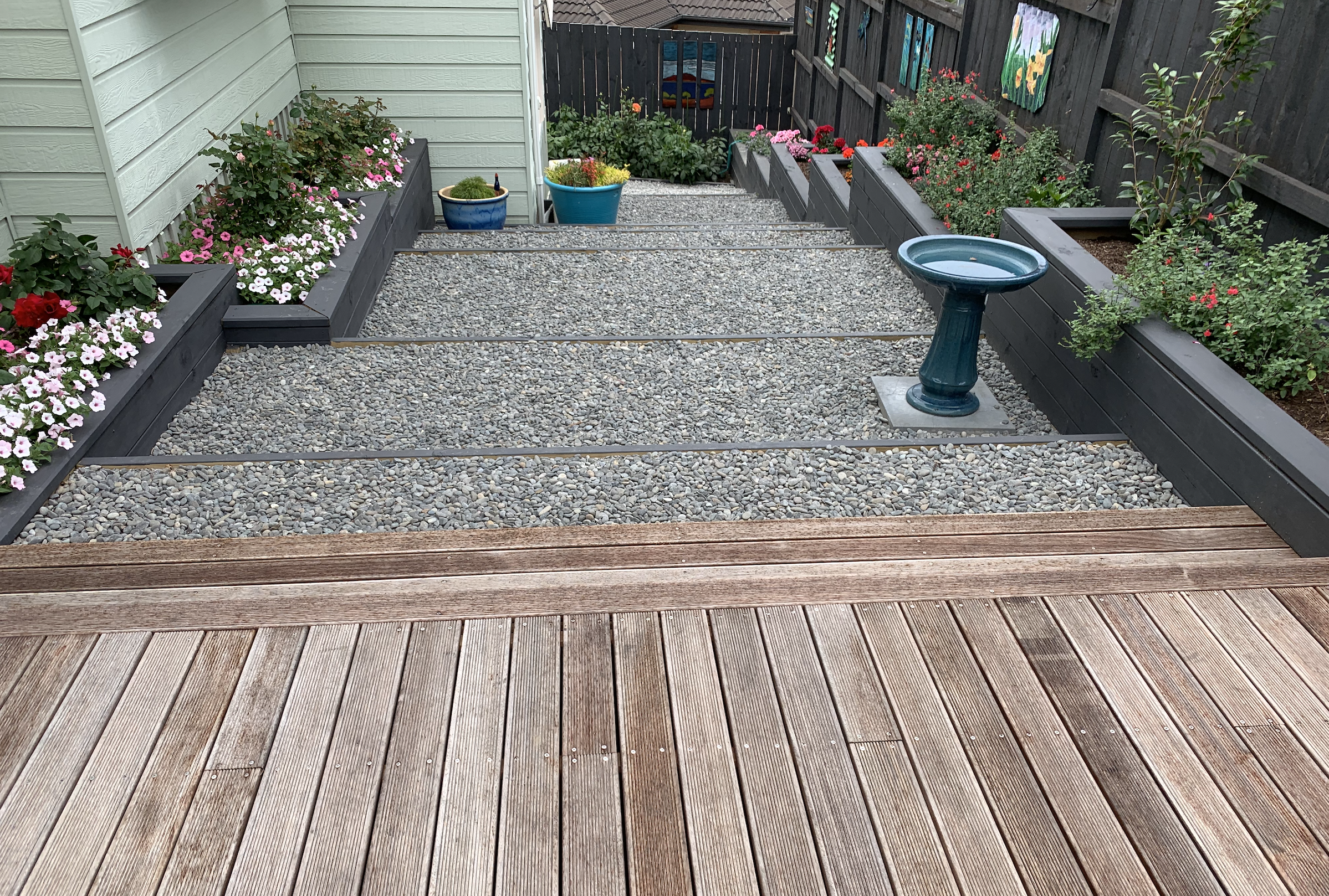 Suburban Garden makeover converting sloped section to year round access new planters, steps and path