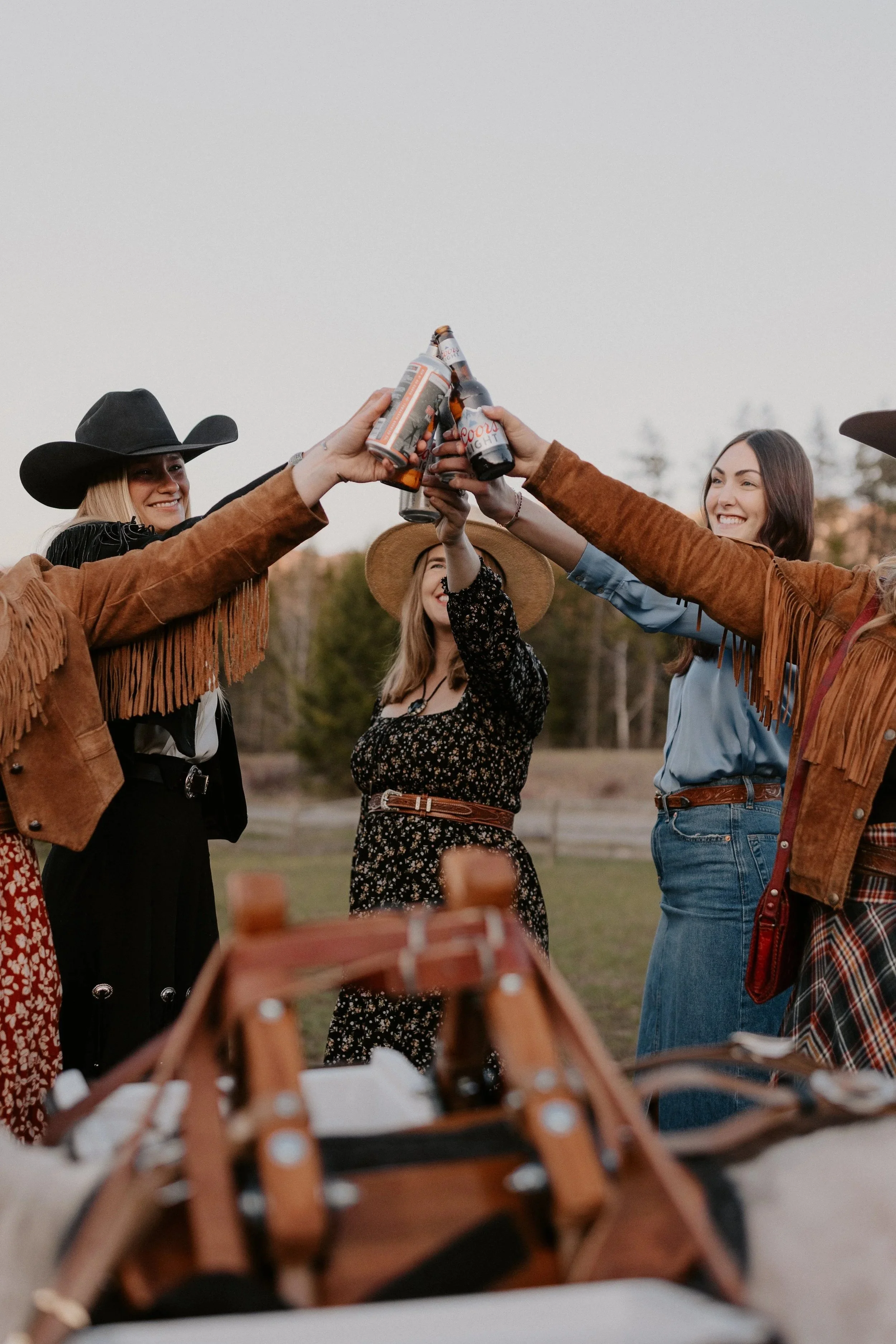 Guests cheersing with local Flathead Valley craft beer against a mountain backdrop, accompanied by a professional and pristine miniature donkey host.