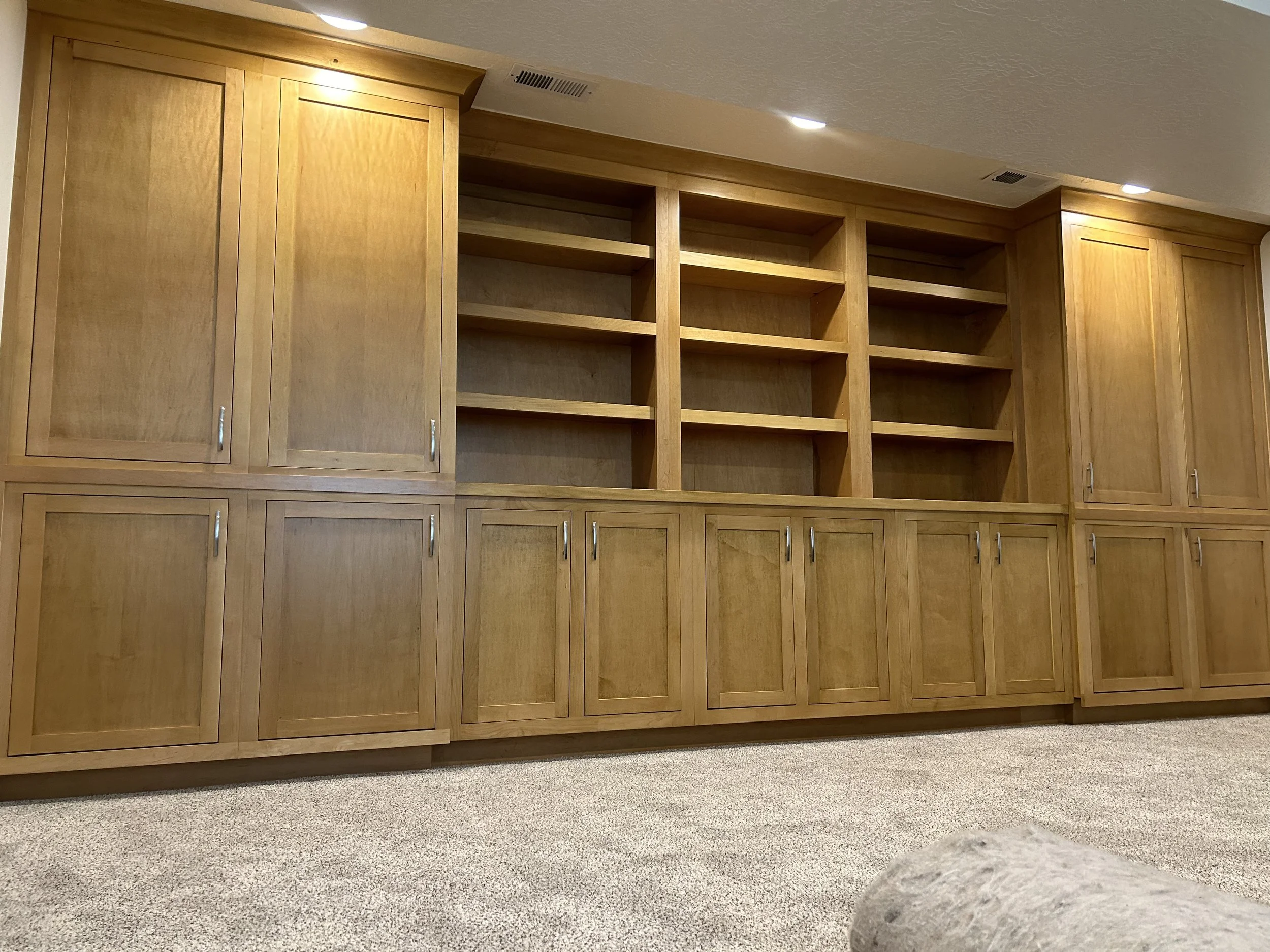 Entirely custom-made built in shelving unit. This client wanted a soft honey-toned unit, that required a custom stain mix. This unit was constructed in 10 individual units, completed on site. 