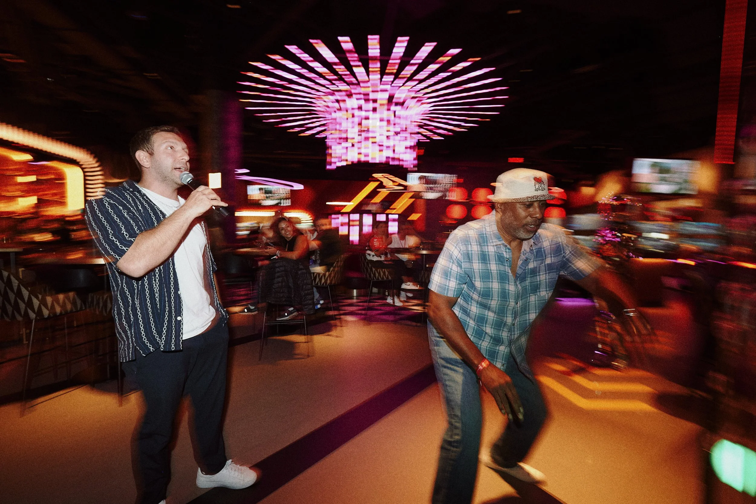 Lee hyping up the F1 Arcade Vegas reaction wall.