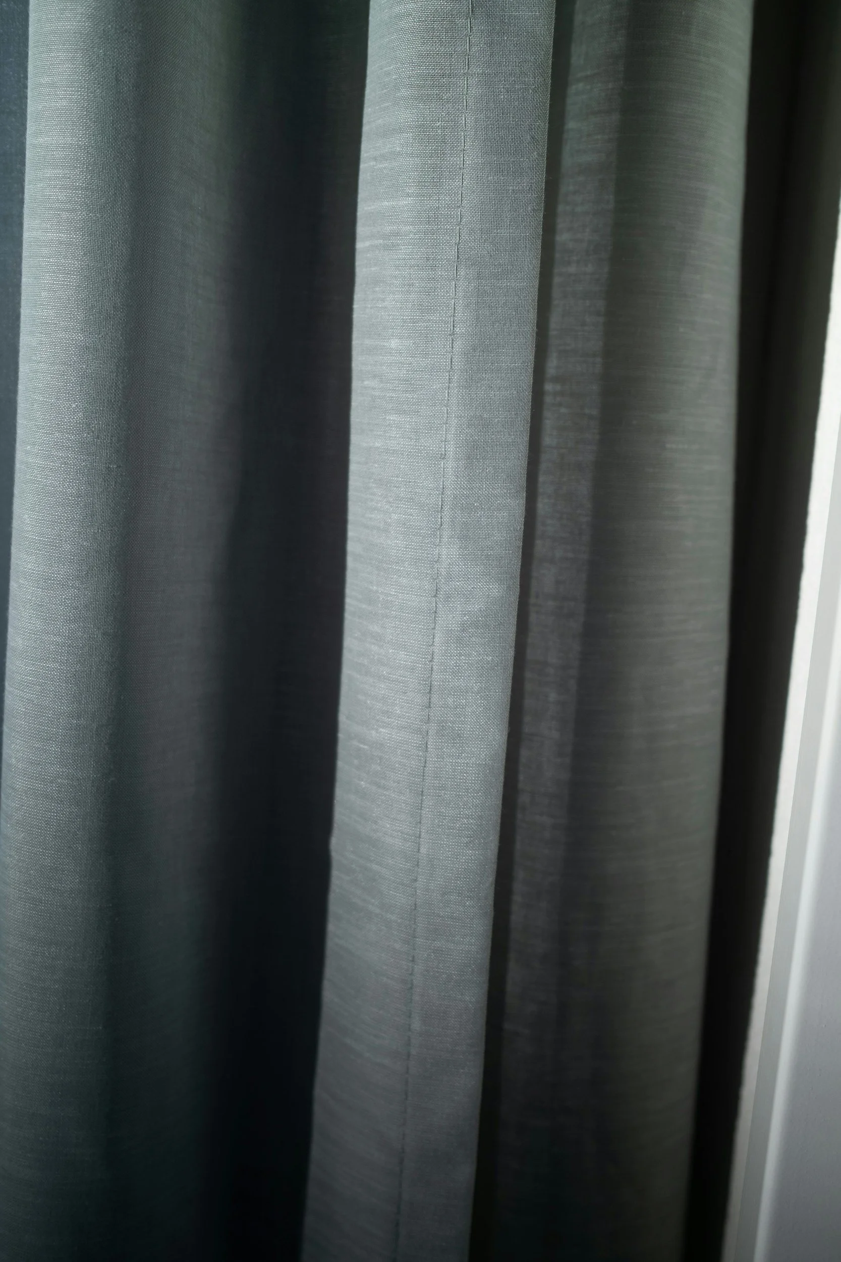 Close-up of layered black and grey fabric panels