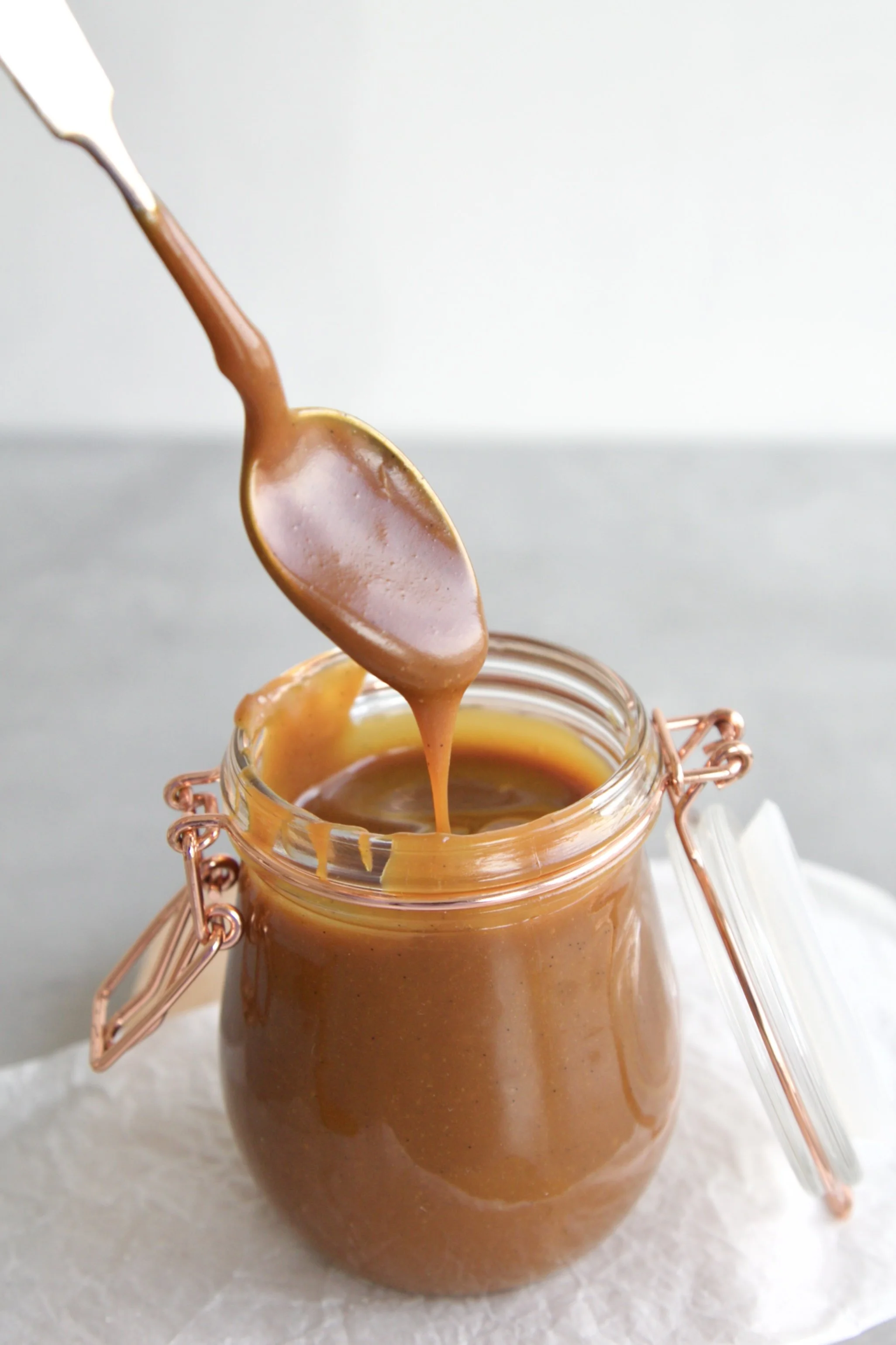 Vanilla caramel sauce dripping from a spoon