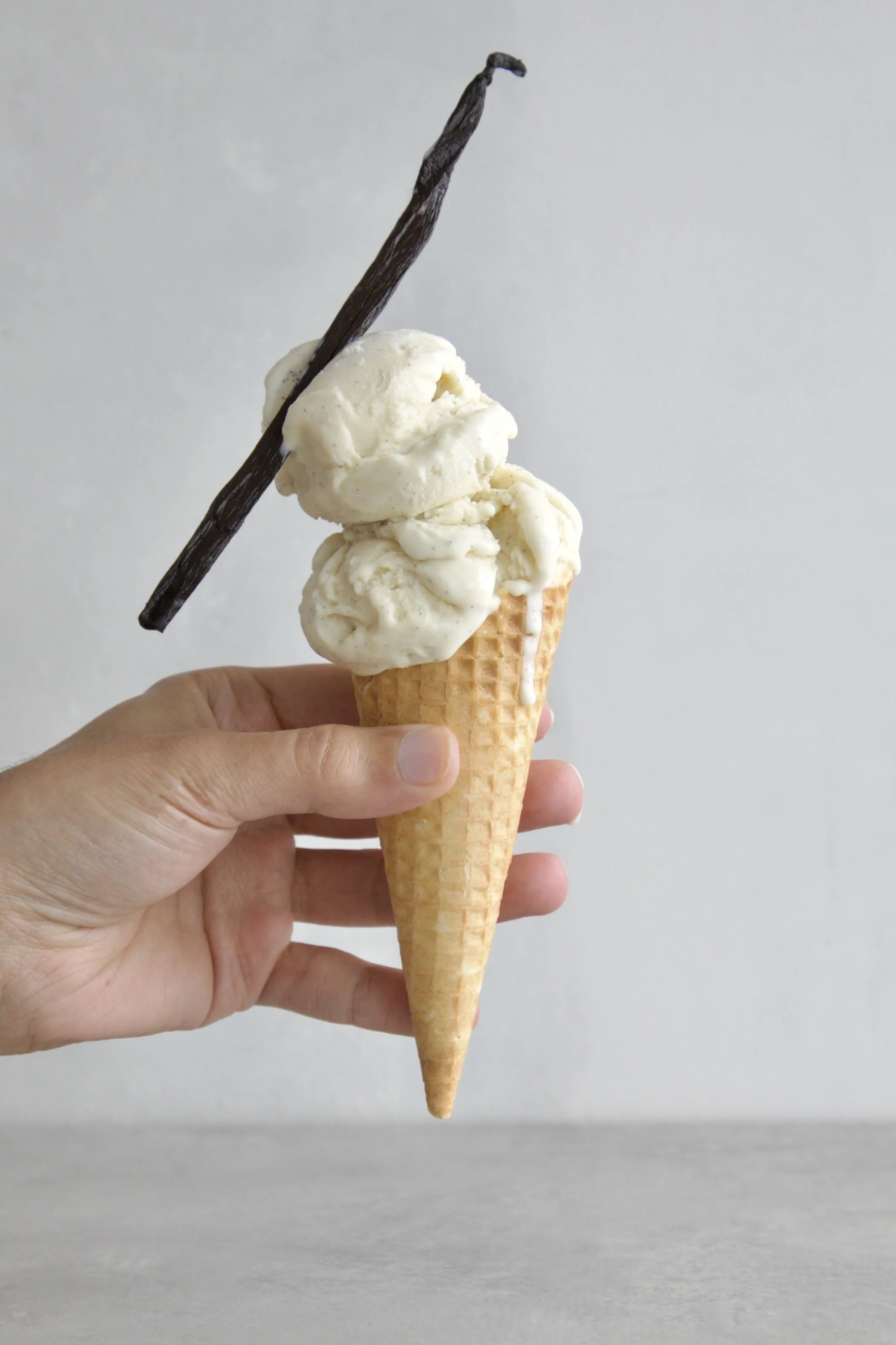 Ice cream cone with 2 scoops of vanilla Fior Di latte ice cream and a vanilla pods for decor