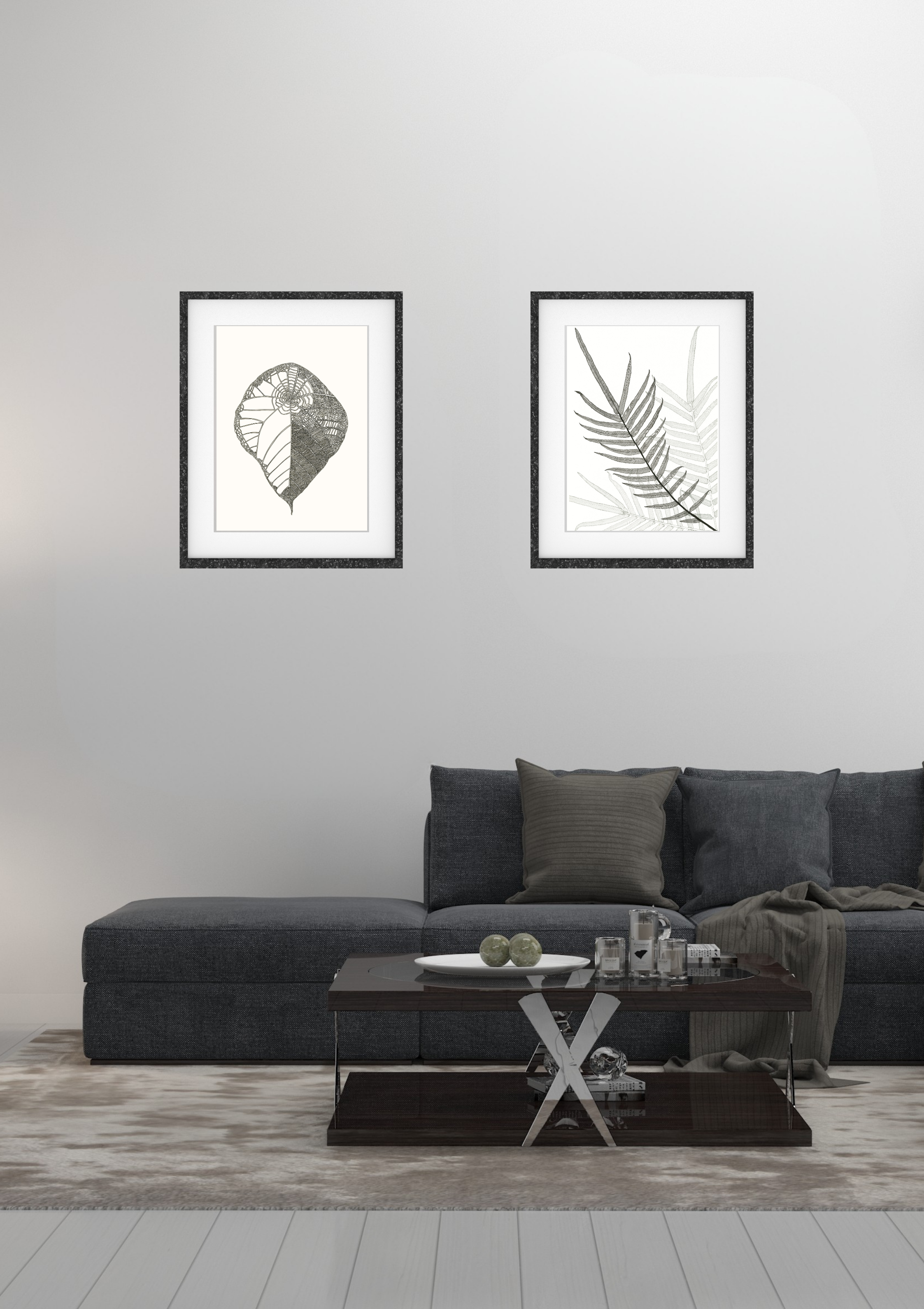 Living room with gray sofa, decorative pillows, coffee table with candles and decorative objects, and two black-and-white framed botanical prints on white wall.