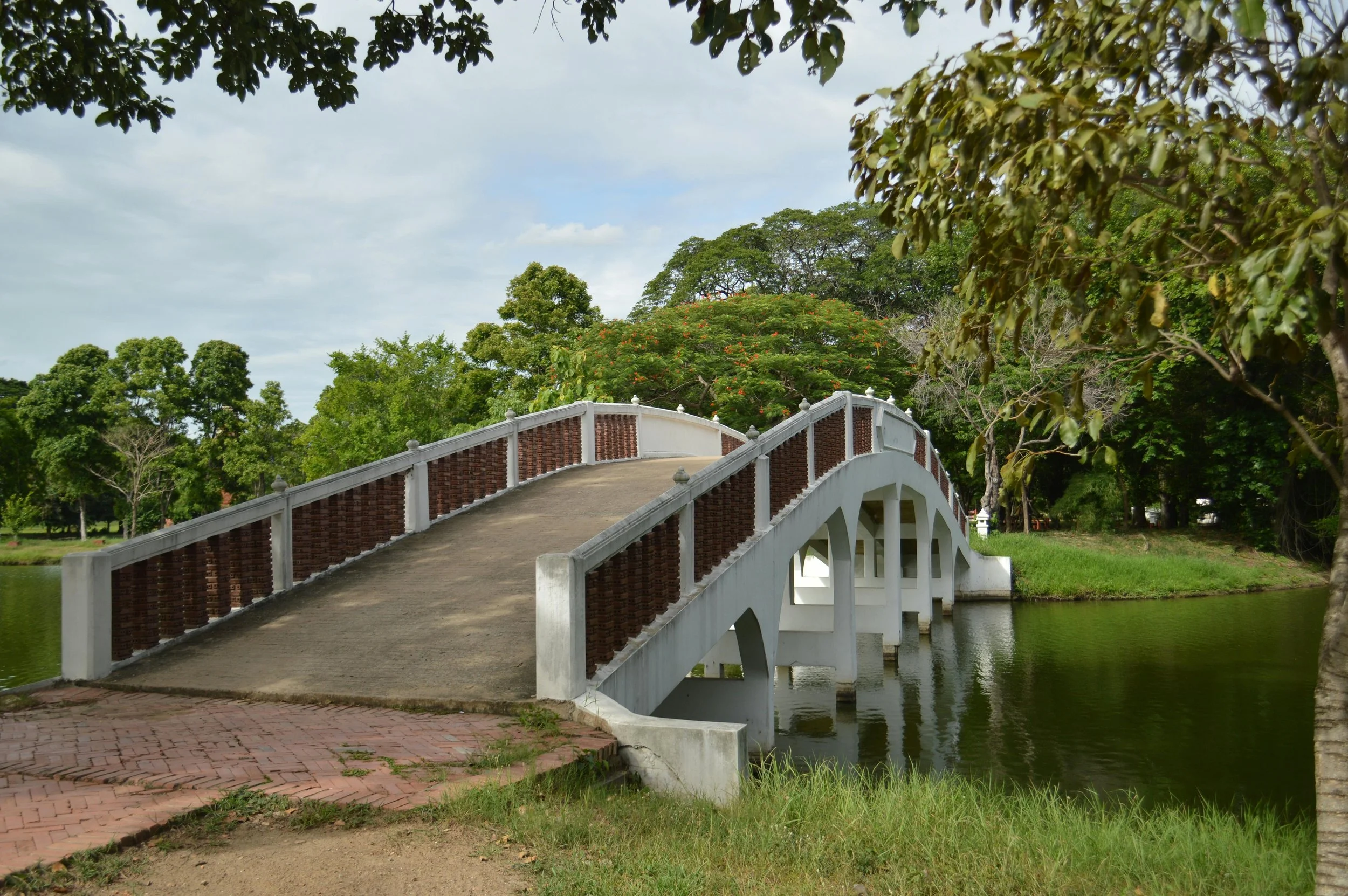 a white bridge going over a river