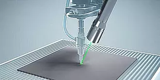 A laser cutting machine engraving a design into a metal sheet.