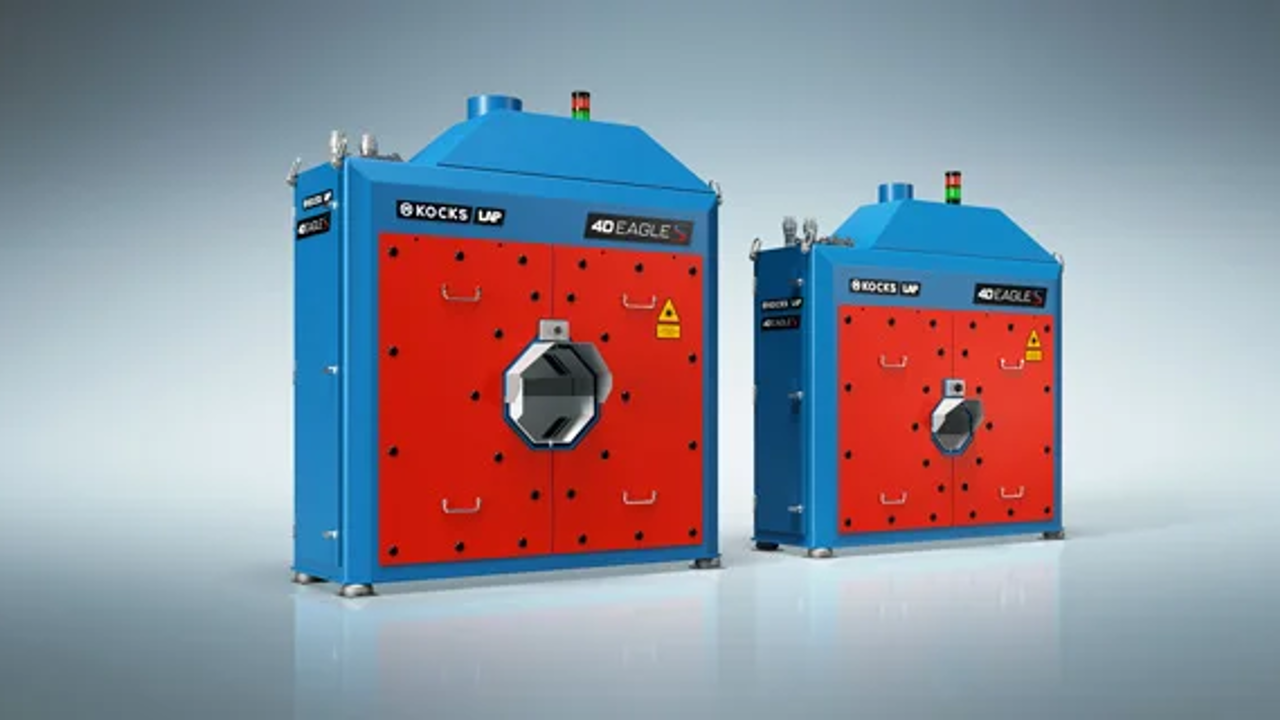 Two industrial heat treatment machines with blue exteriors and red front panels.