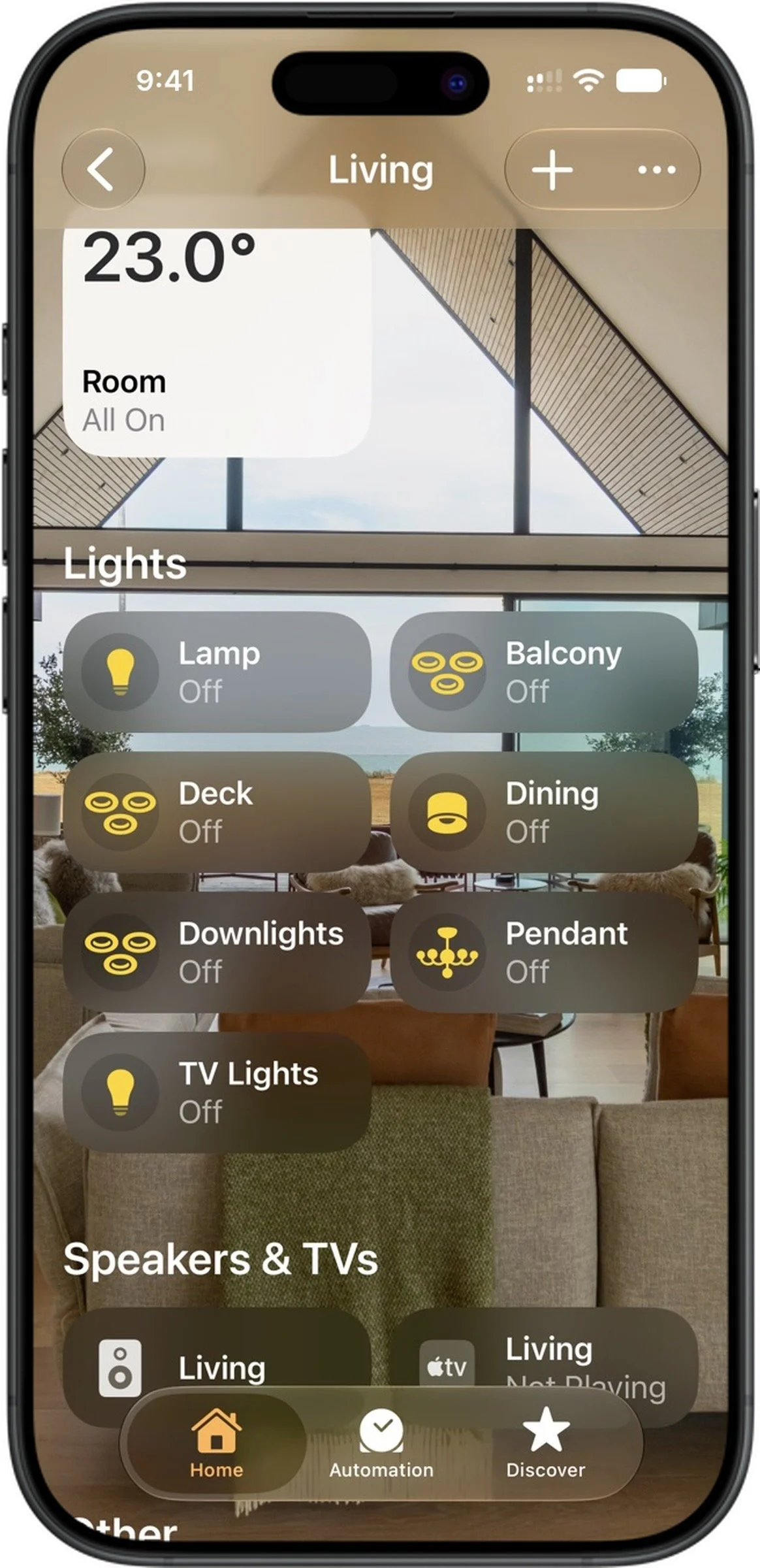 Smartphone screen displaying a home automation app with the living room temperature at 23 degrees Celsius, various light controls showing all lights are off, and icons for speakers and TVs, with navigation buttons at the bottom.
