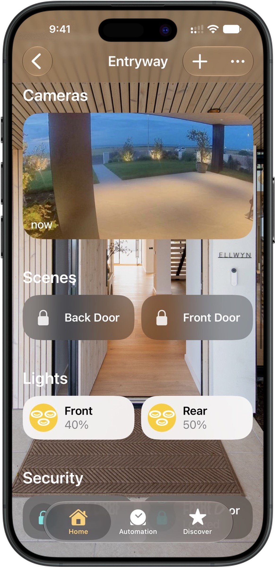 Smart home security app interface displaying live camera feed of an outdoor patio, indoor hallway with front and back door controls, and lighting controls for front and rear lights with adjustable brightness percentages.