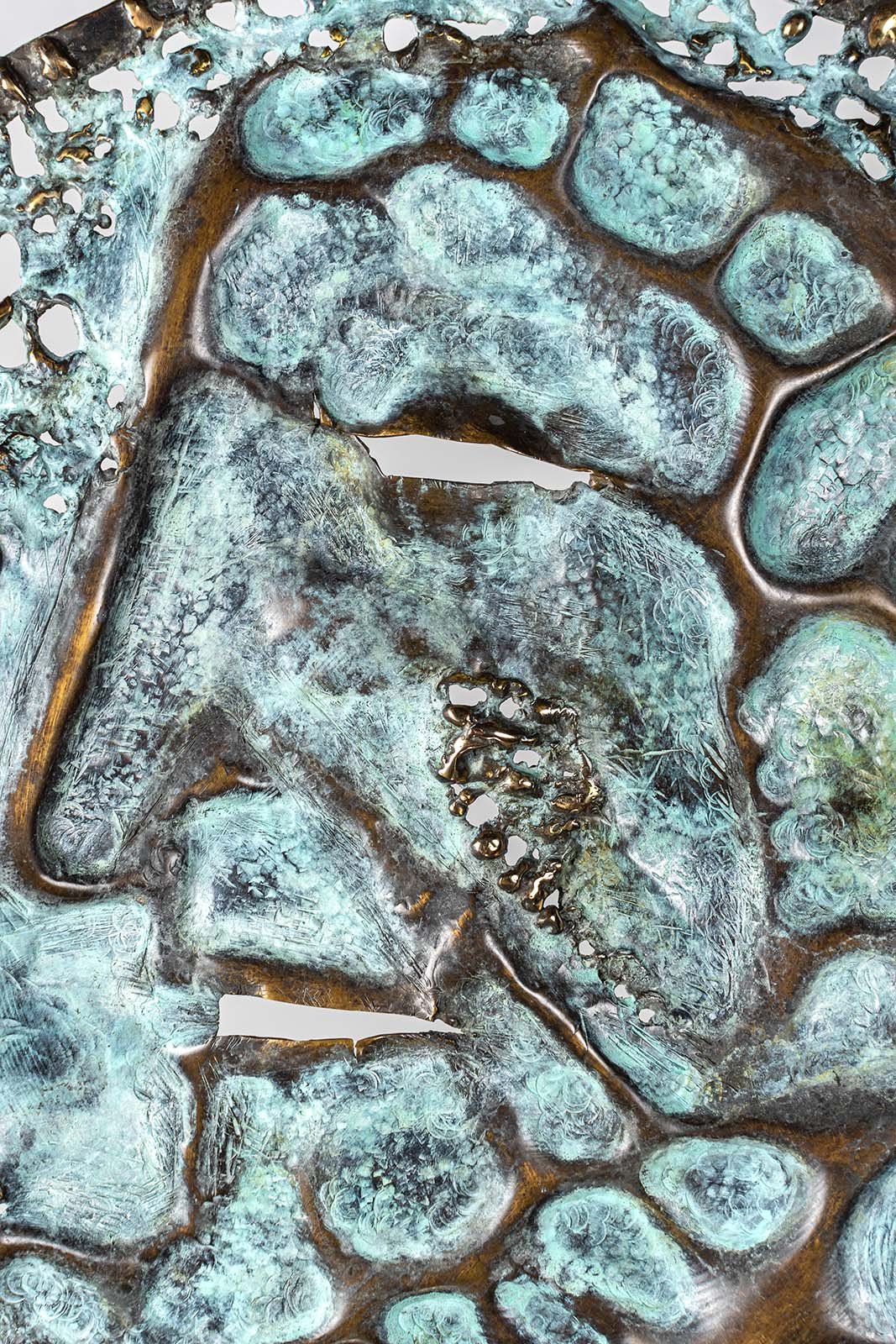 Some see a face in it. The metal was melted under the torch and drawn while molten, then frozen into the design as it cooled.