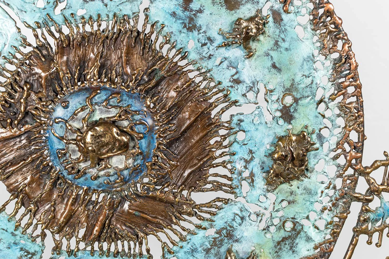 Macro, central burst

The center worked in torch-drawn bronze over turquoise patina.