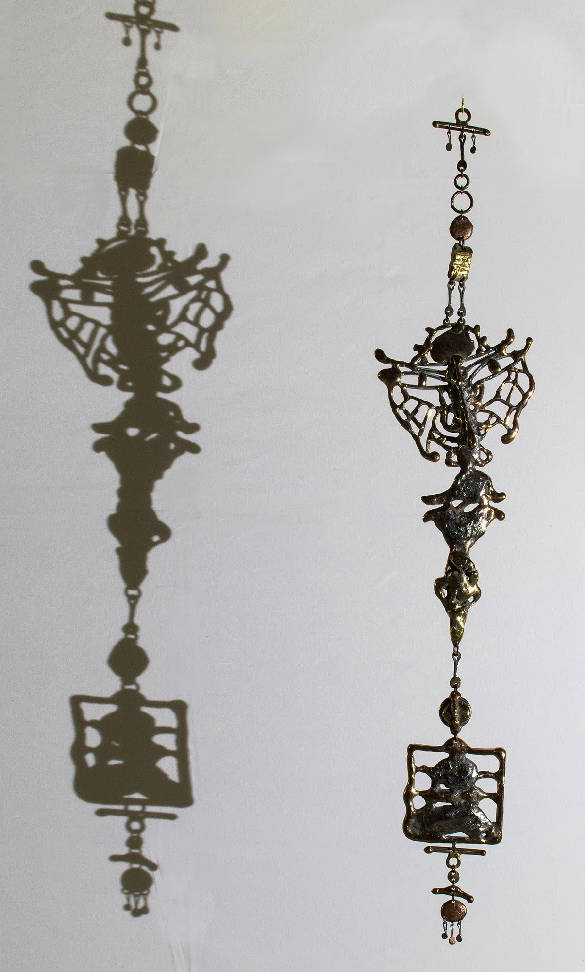 The shadow is the work with everything taken away: no colour, no patina, no shine. Only the shape, and the shape cannot lie.