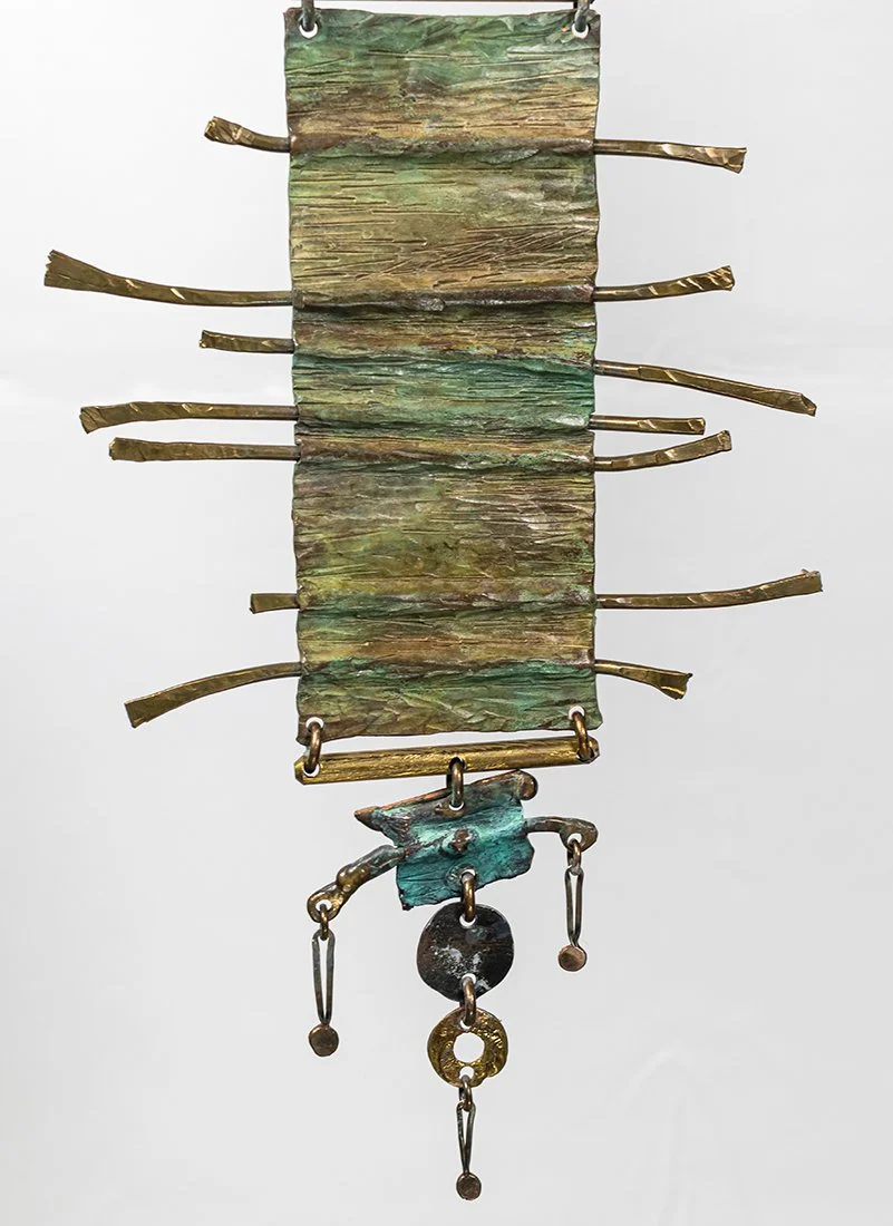 Brass rods cross the panel the way threads cross a loom, holding the field in tension.