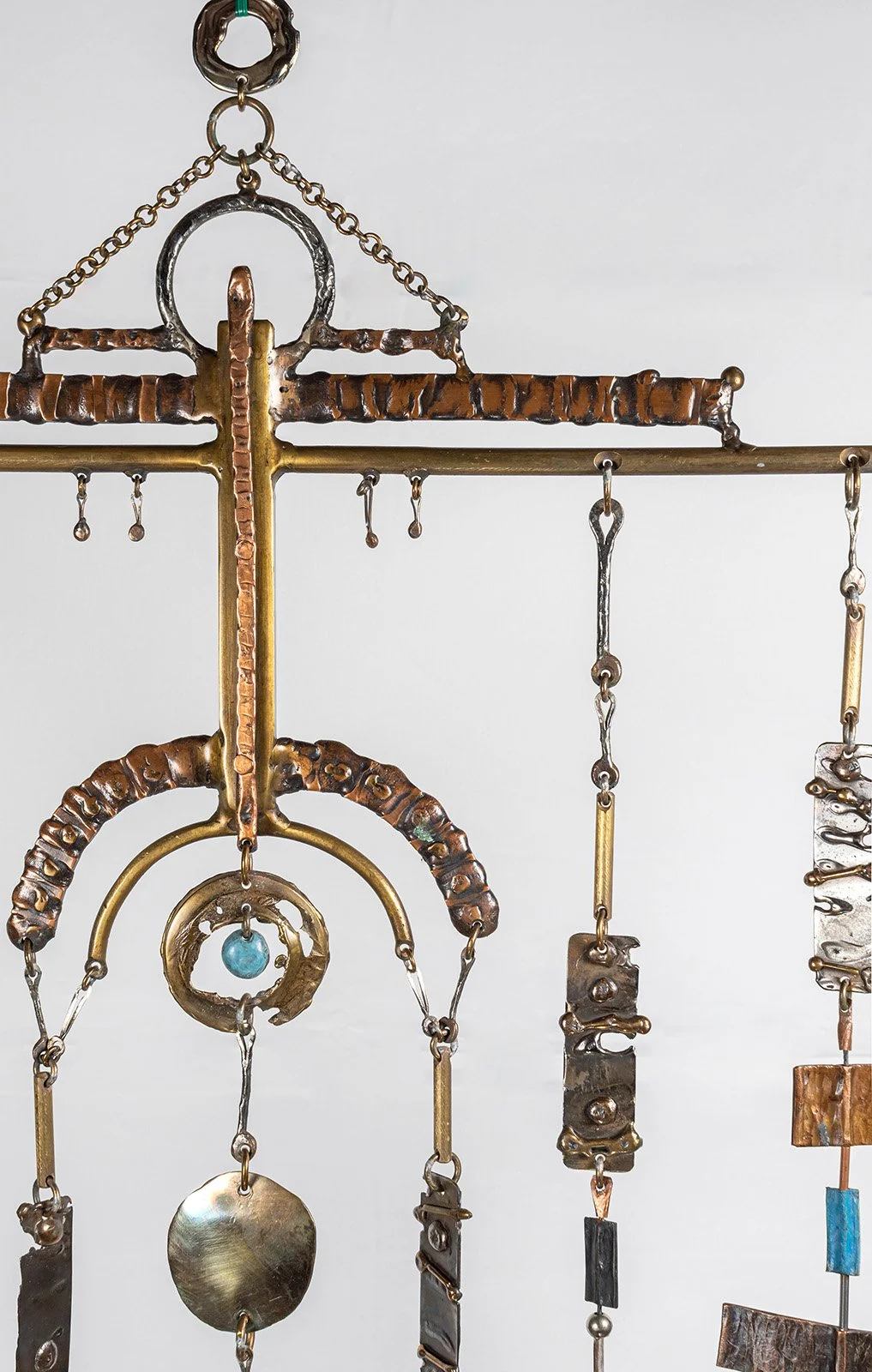 The bar carries nine lines the way a loom carries warp, each hung free and weighted differently.
