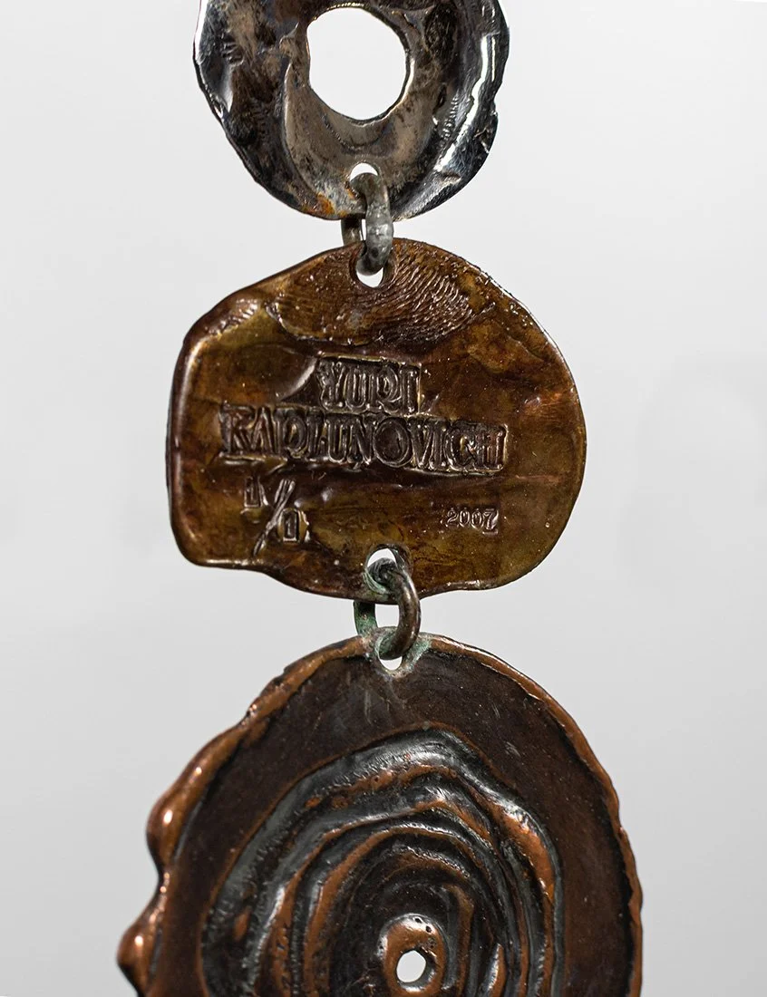 Detail thumbprint.

The artist's thumbprint pressed into bronze, beside the name, the year, and the mark 1 of 1.