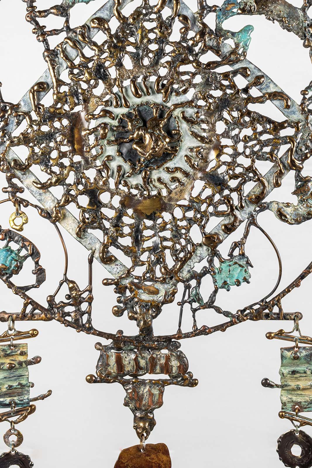 The centre is drawn, not modelled. Bronze melted under the flame and lay down in a line, the way ink is laid on paper.