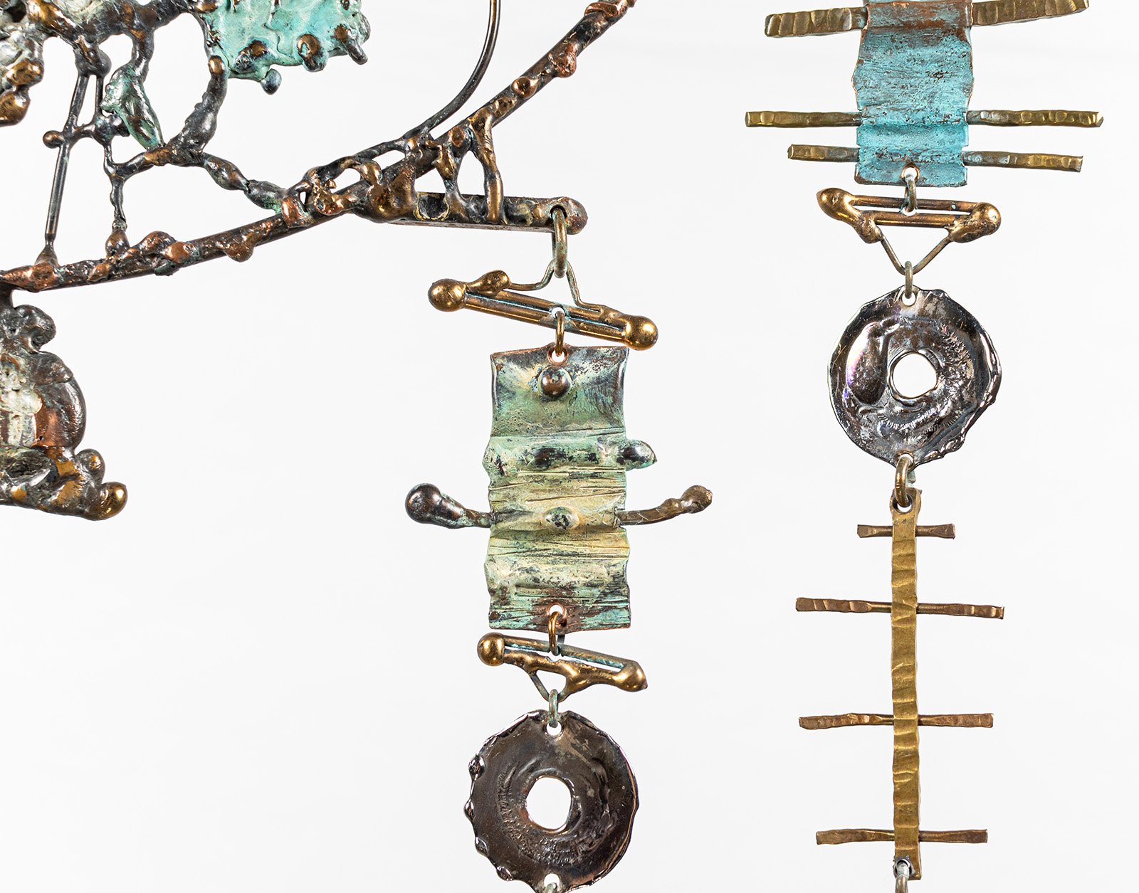 Copper, bronze, along and satinless steel, melted under the flame until the patina moved like water, then stopped.
