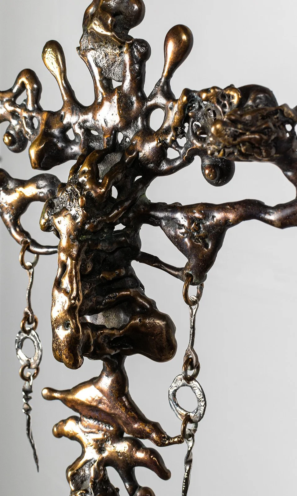 The torch does the sculpting, working the bronze while it is soft, drawing the nose up out of the mass and letting the face come with it. Nothing was carved and nothing was modelled in clay first.